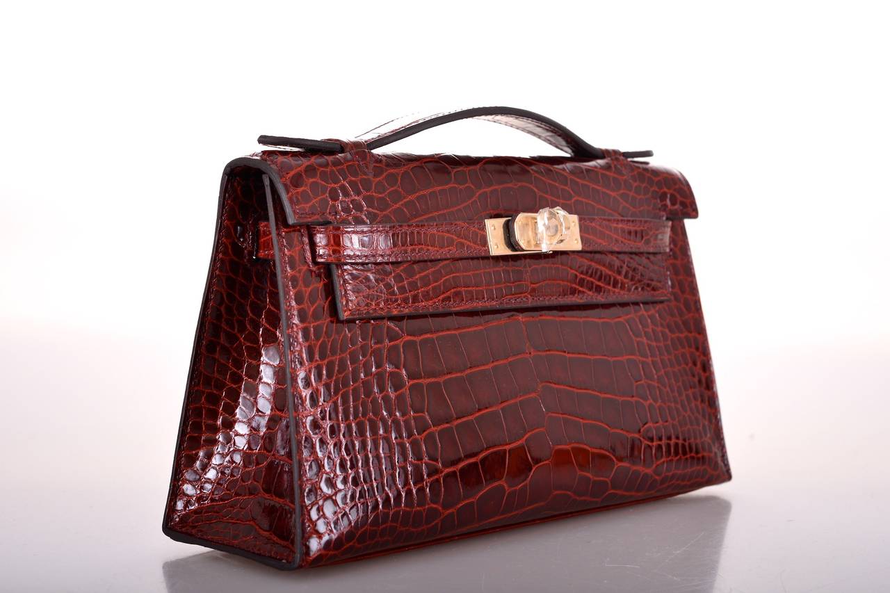 As always, another one of my fab finds! Hermes SHINY KELLY POCHETTE IN THE MOST AMAZING NEW DEEP RED called BOURGOGNE  ALLIGATOR! THE MOST GORGEOUS RED EVER with PERMABRASS hardware!

                           MEASUREMENTS:
LENGTH: 8.5