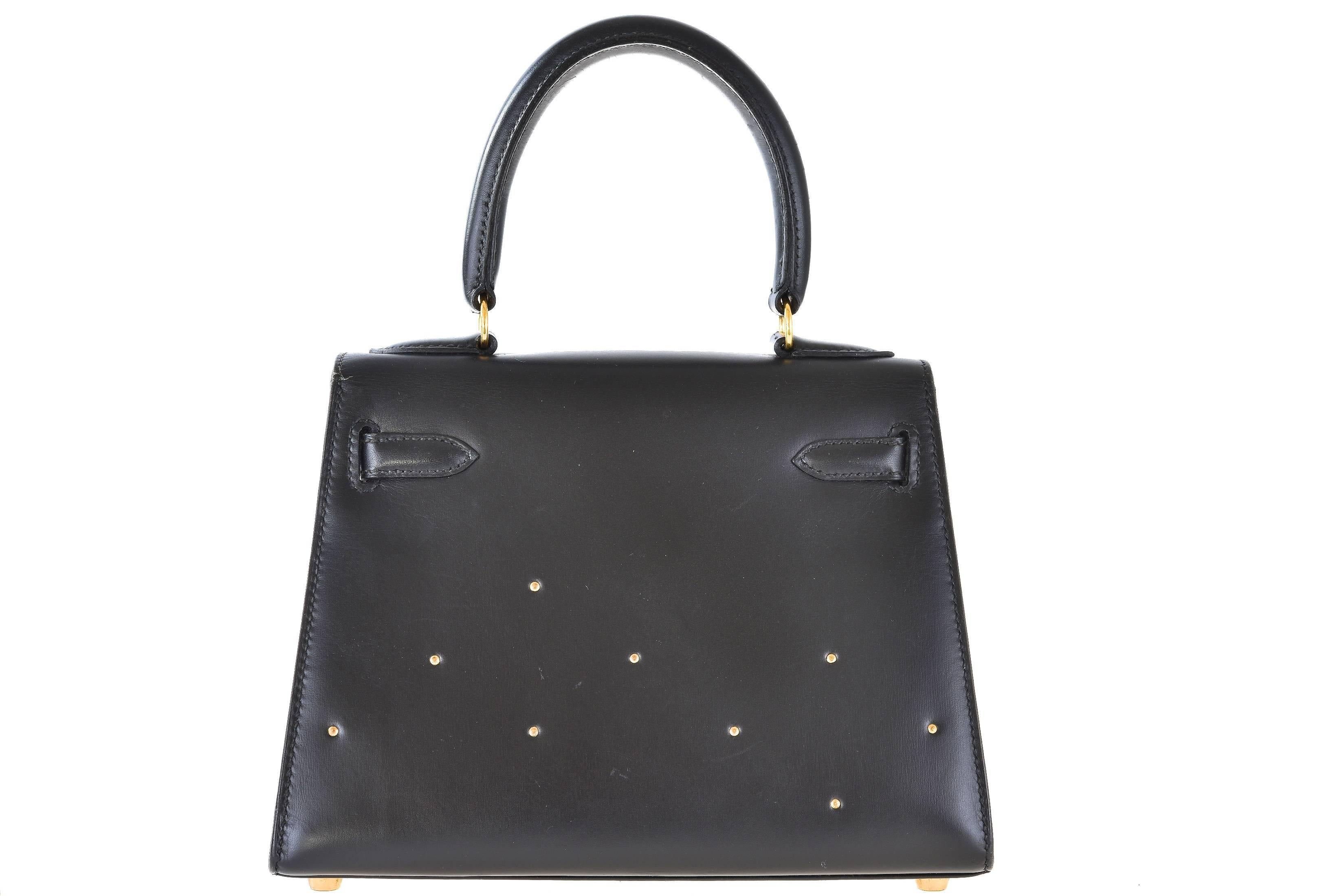 Excellent Condition 

The Hermes Kelly you have never seen! Kelly in black box with gold studs. The strap is custom 50” long, perfect for cross body.

This 20cm Cross body Kelly bag by Hermès in black box & gold Rock & Roll studs, gold