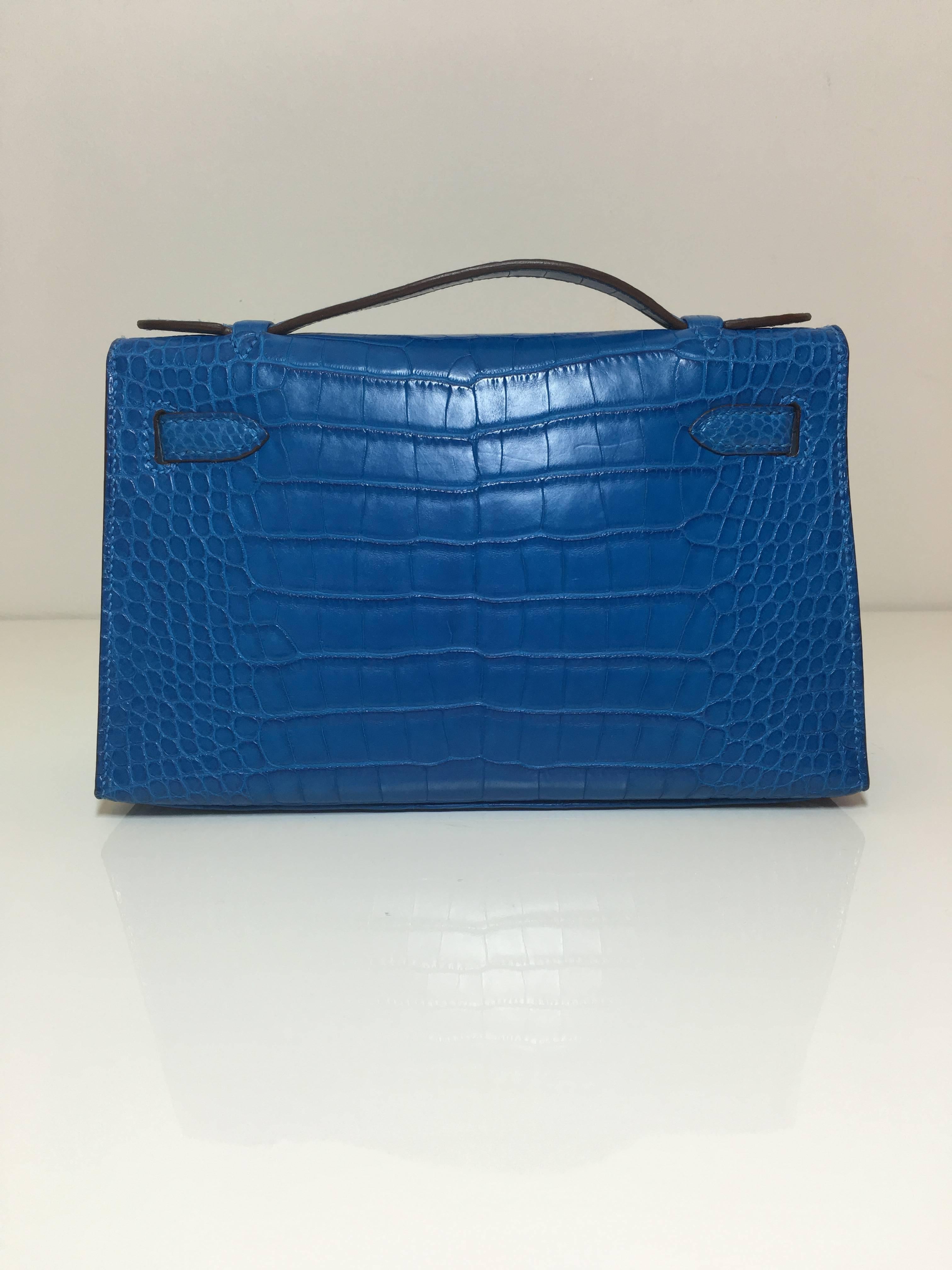 Rare Hermes Kelly Pochette
alligator matt
Colour  blue Mykonos
palladium hardware 
STORE FRESH, comes with receipt and full set (dust bag, box, cities...) 
Hydeparkfashion specializes in sourcing and delivering authentic luxury handbags, mainly