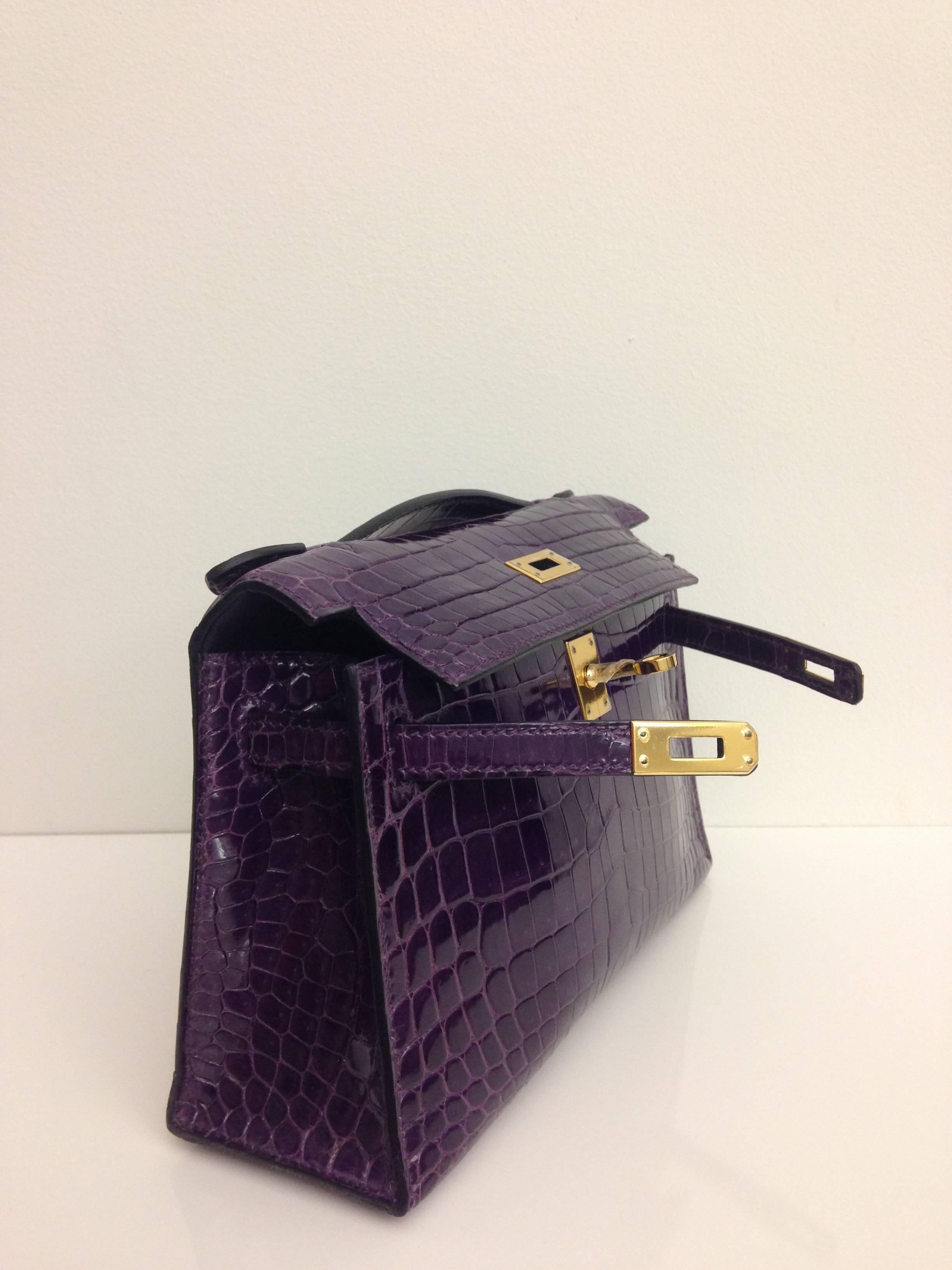 Hermes, Kelly Pochette bag, Colour Amethyste, Shiny Crocodile skin - Alligator, Gold Hardware.

This Bag comes with a box, dustbag and manual 
