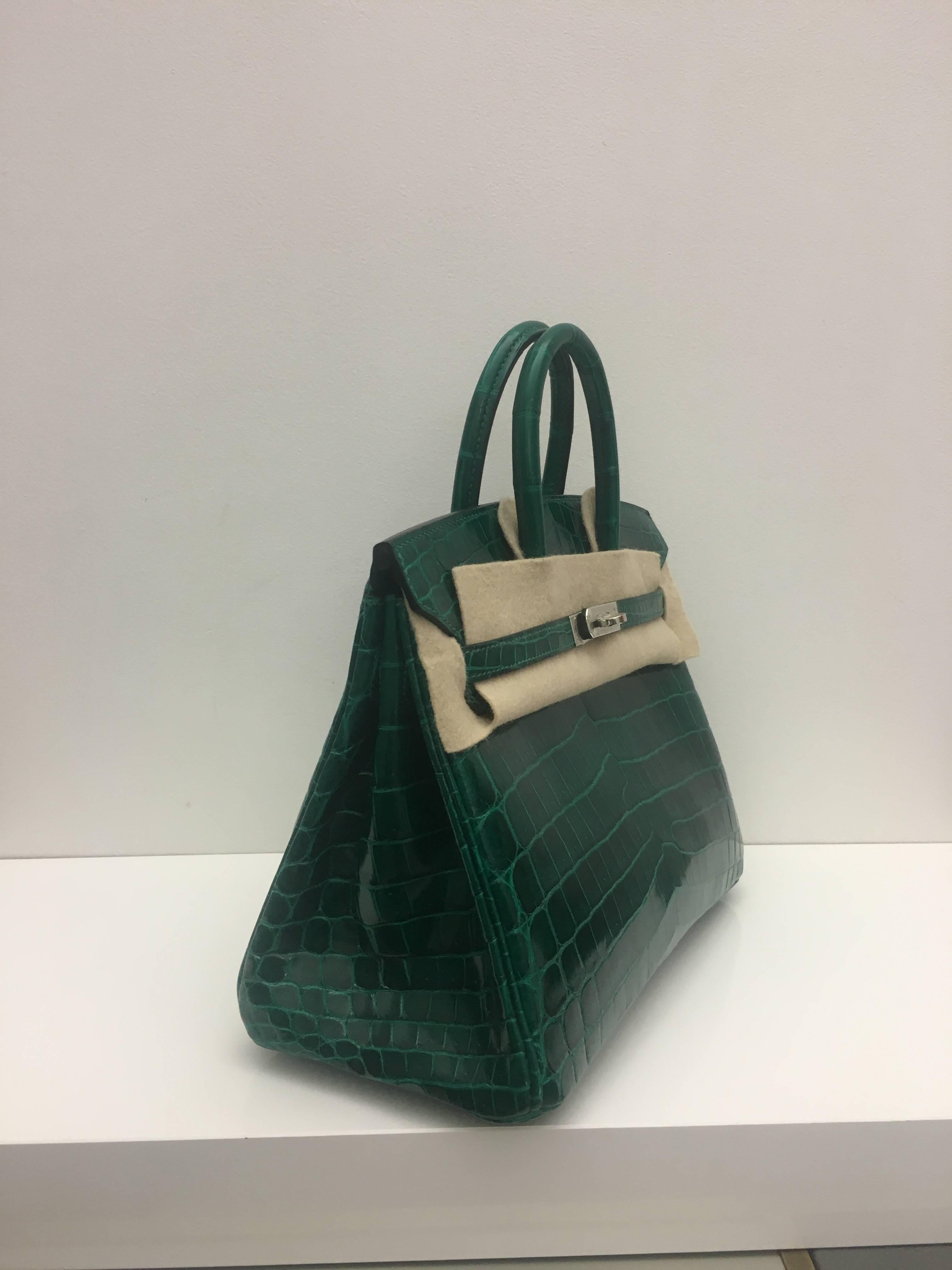 Hermes 
Birkin Size 25
Shiny Niloticus Croc
Colour Emerald Green 
Silver Hardware 
store fresh, comes with receipt and full set (dust bag, box...) 
Hydeparkfashion specializes in sourcing and delivering authentic luxury handbags, mainly
