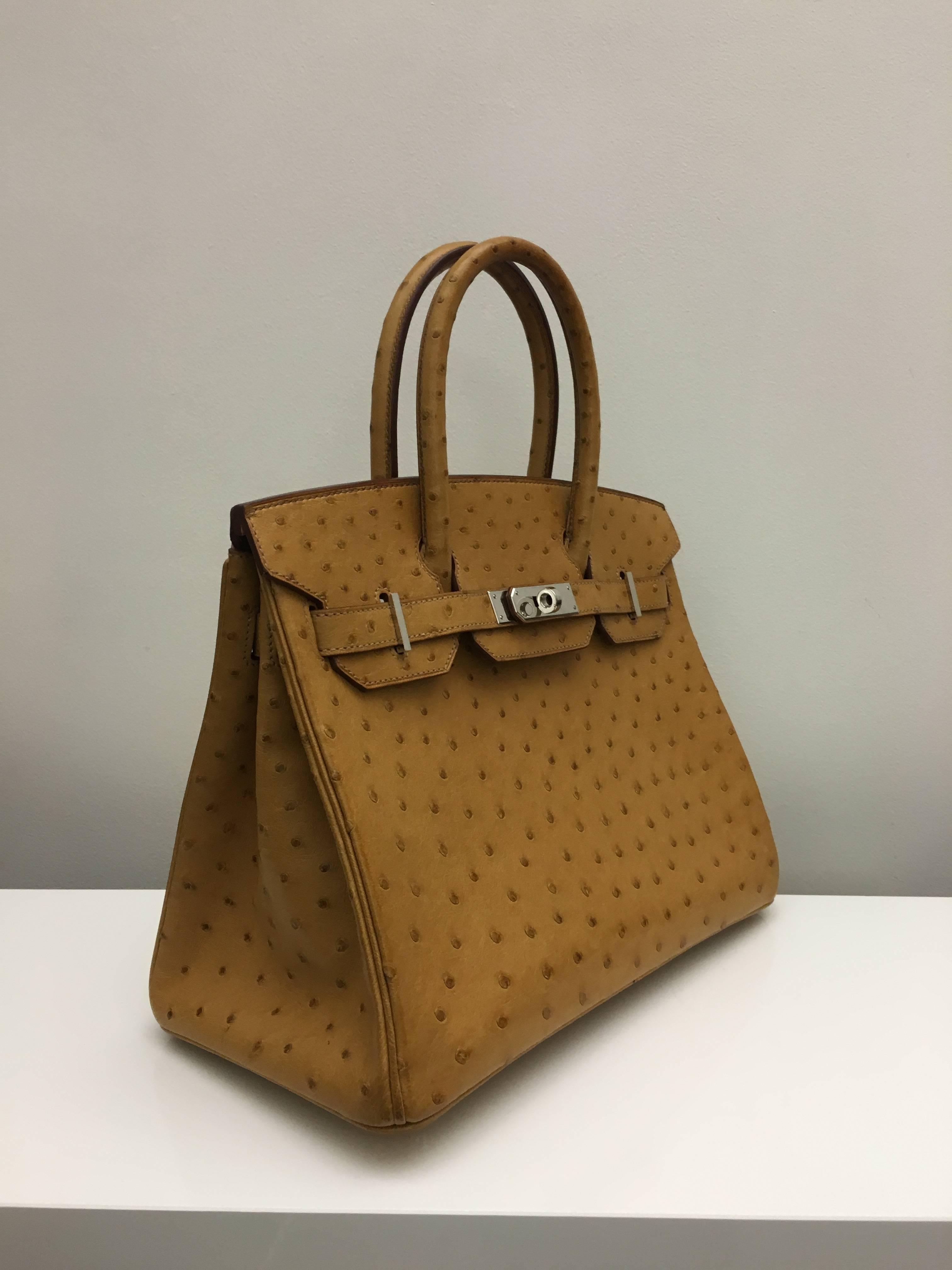 Hermes 
Birkin Size 30
Ostrich Leather 
Colour Tabac Gold
Palladium (silver) Hardware 
store fresh, comes with receipt and full set (dust bag, box...) 
Hydeparkfashion specializes in sourcing and delivering authentic luxury handbags, mainly