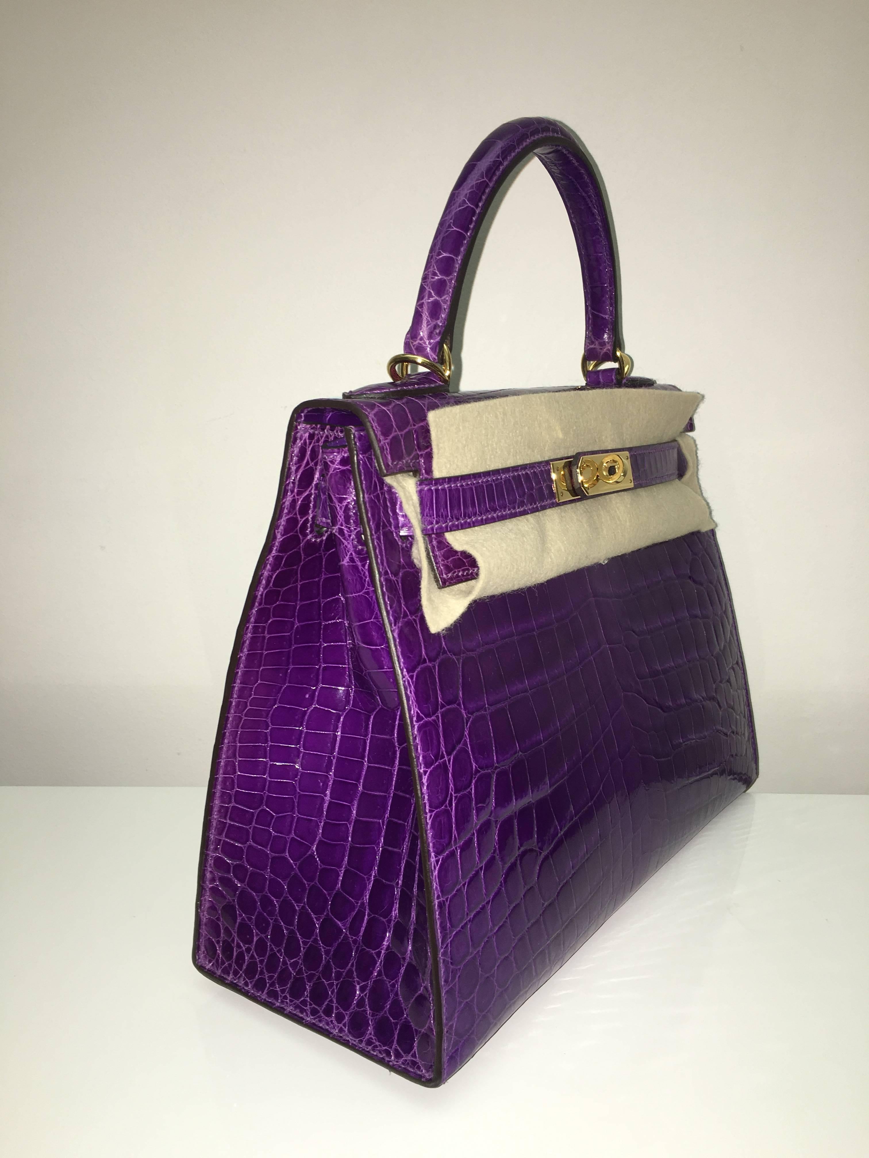 Hermes 
Kelly Size 28
Shiny Crocodile Skin (Leather) 
Colour Ultra-Violet
Gold Hardware 
store fresh, comes with receipt and full set (dust bag, box...) 
Hydeparkfashion specializes in sourcing and delivering authentic luxury handbags, mainly