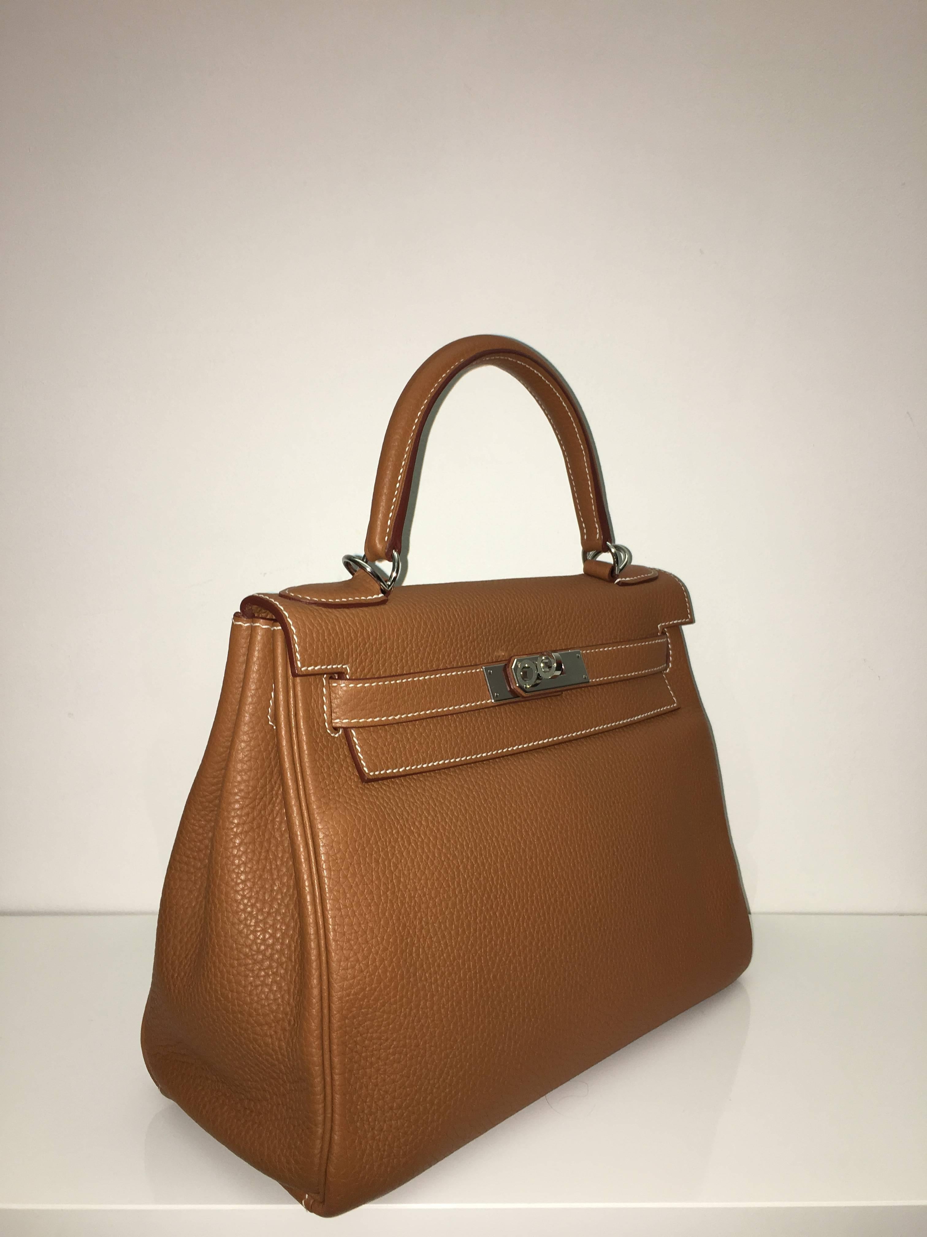 Hermes 
Kelly Size 28
Togo Leather 
Colour Camel Gold
Palladium (Silver) Hardware 
store fresh, comes with receipt and full set (dust bag, box...) 
Hydeparkfashion specializes in sourcing and delivering authentic luxury handbags, mainly
