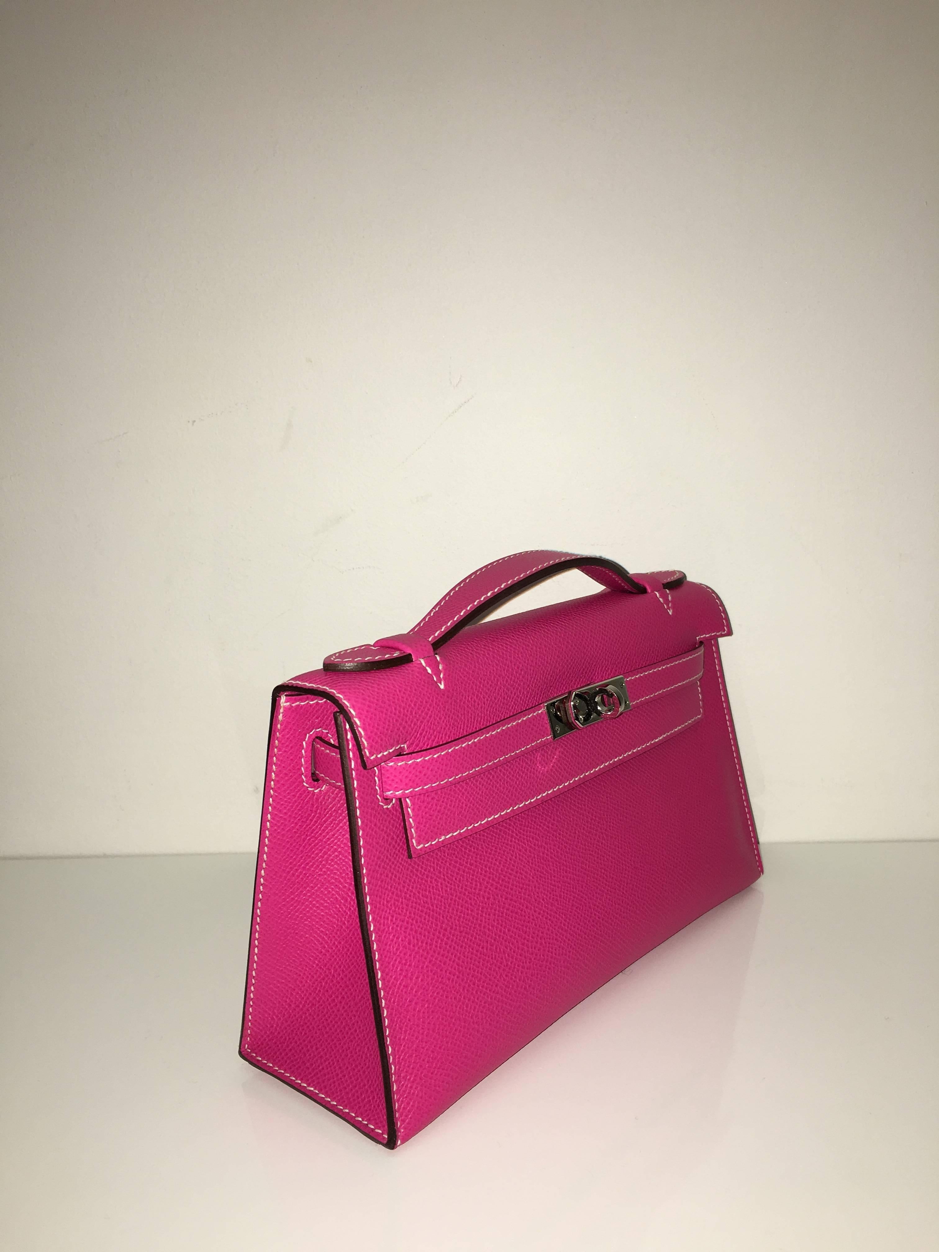 Hermes 
Kelly Pochette
Epsom Leather 
Colour Rose Tyrien
Palladium (Silver) Hardware 
store fresh, comes with receipt and full set (dust bag, box...) 
Hydeparkfashion specializes in sourcing and delivering authentic luxury handbags, mainly