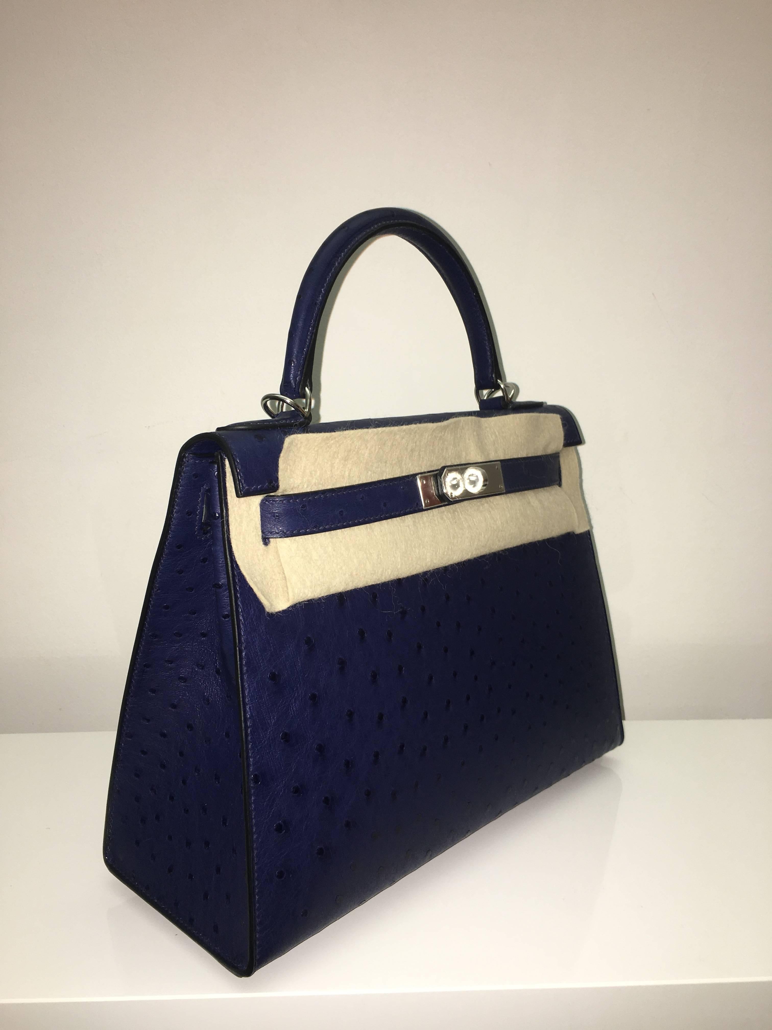Hermes 
Kelly Size 28
Ostrich Skin
Colour Blue Iris
Silver (palladium) Hardware 
store fresh, comes with receipt and full set (dust bag, box...) 
Hydeparkfashion specializes in sourcing and delivering authentic luxury handbags, mainly Hermes,