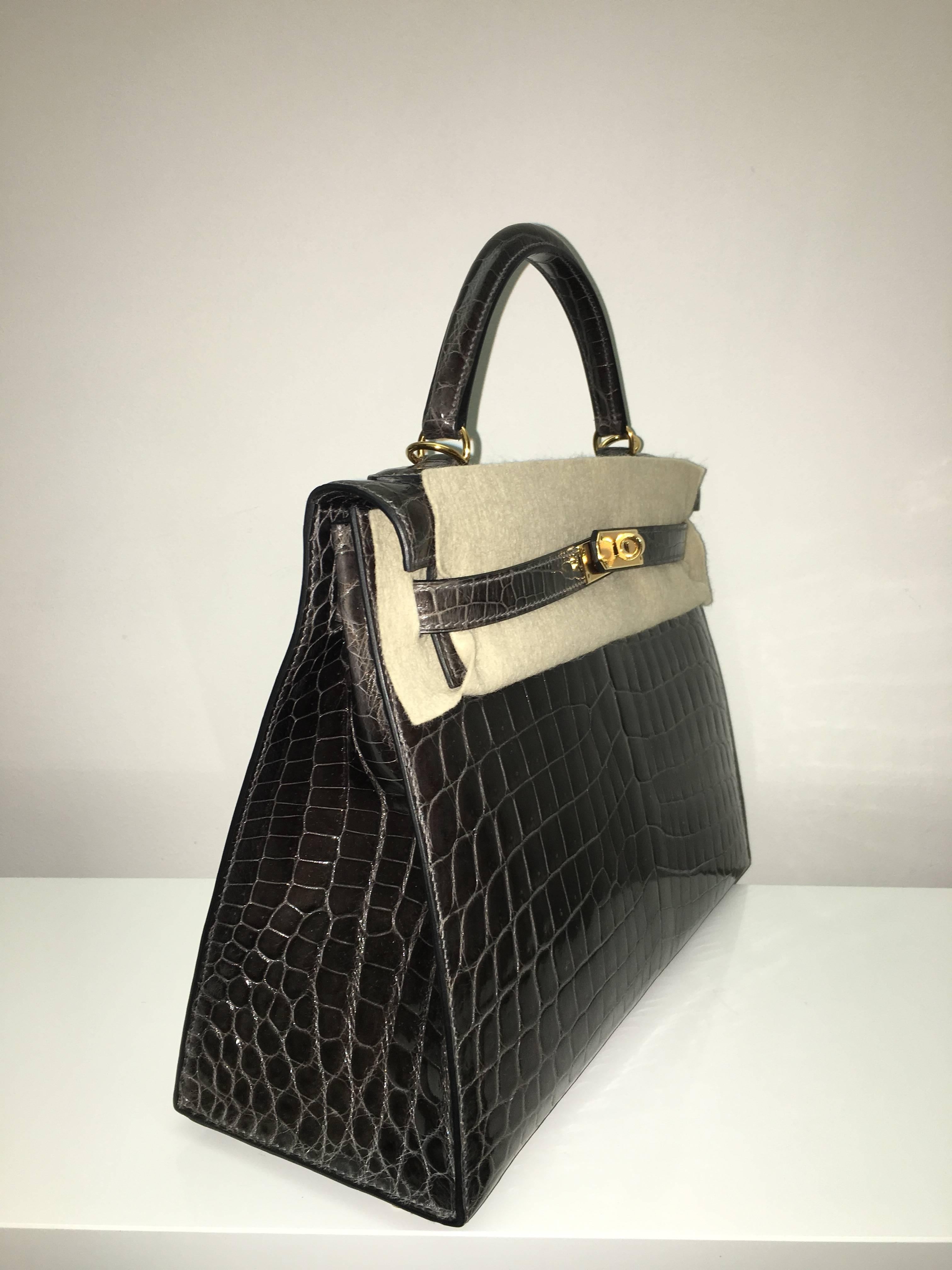 Hermes 
Kelly Size 32
Shiny Croc Leather 
Colour Graphite
Gold Hardware 
store fresh, comes with receipt and full set (dust bag, box...) 
Hydeparkfashion specializes in sourcing and delivering authentic luxury handbags, mainly Hermes, to