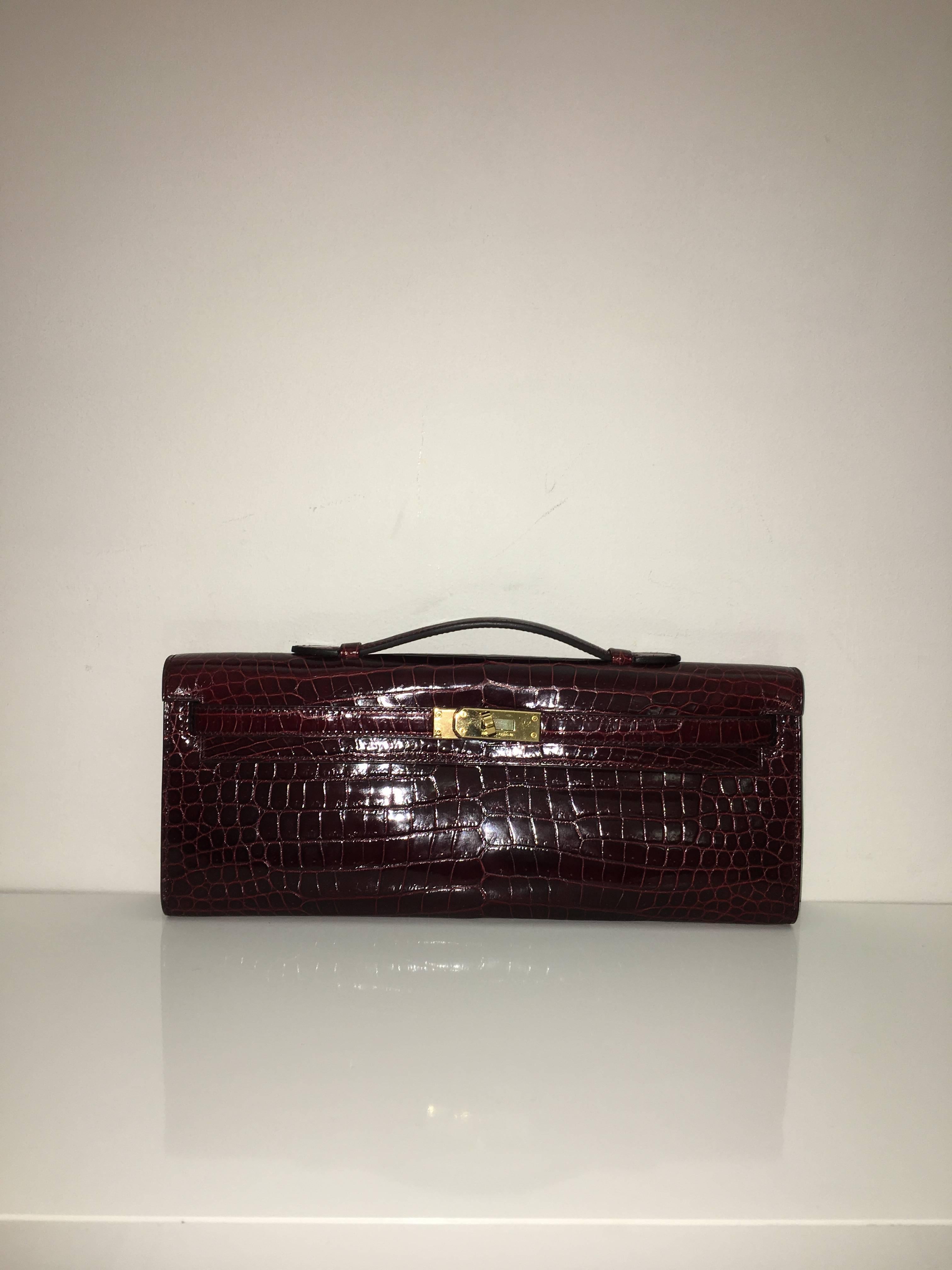 Hermes 
Kelly Cut
Shiny Crocodile Skin
Colour Bourgogne
Gold Hardware 
store fresh, comes with receipt and full set (dust bag, box...) 
Hydeparkfashion specializes in sourcing and delivering authentic luxury handbags, mainly Hermes, to client