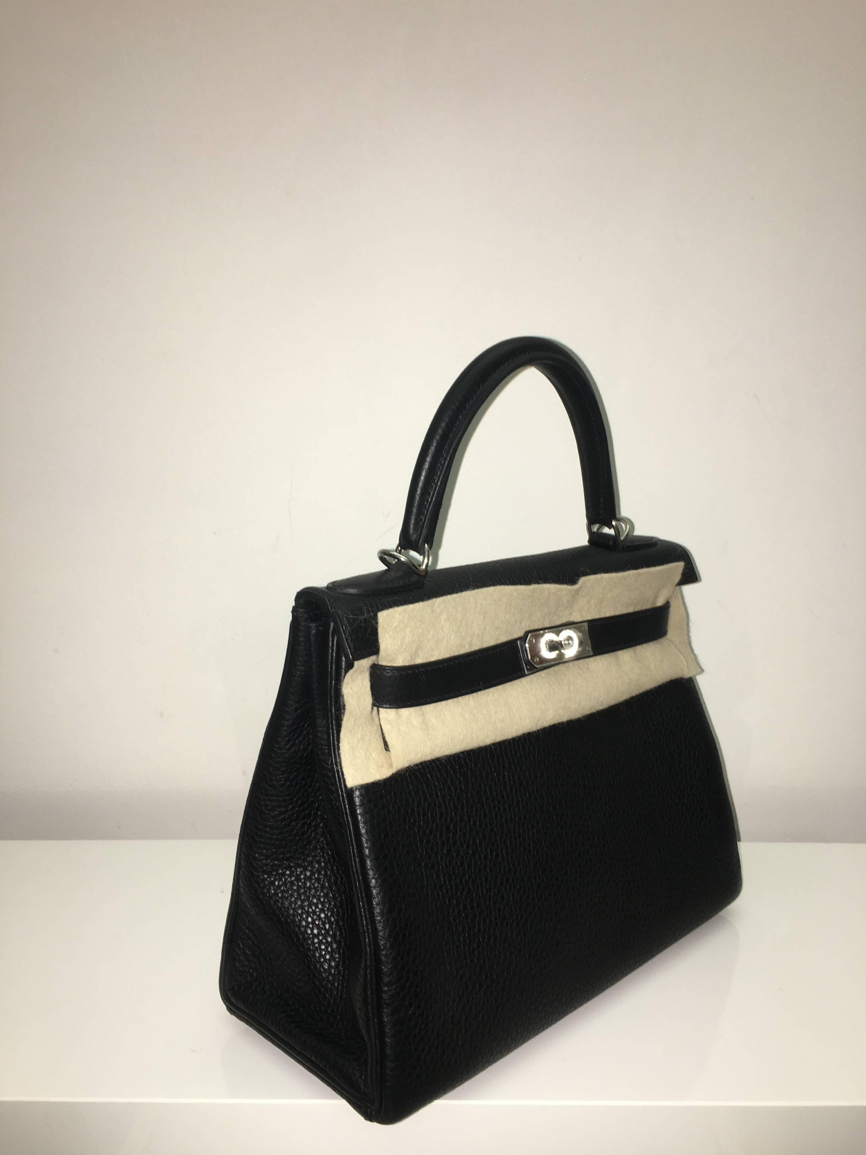 Hermes 
Kelly Size 28
Togo Leather 
Colour Black (Noir)
Silver (Palladium) Hardware
store fresh, comes with receipt and full set (dust bag, box...) 
Hydeparkfashion specializes in sourcing and delivering authentic luxury handbags, mainly Hermes, to