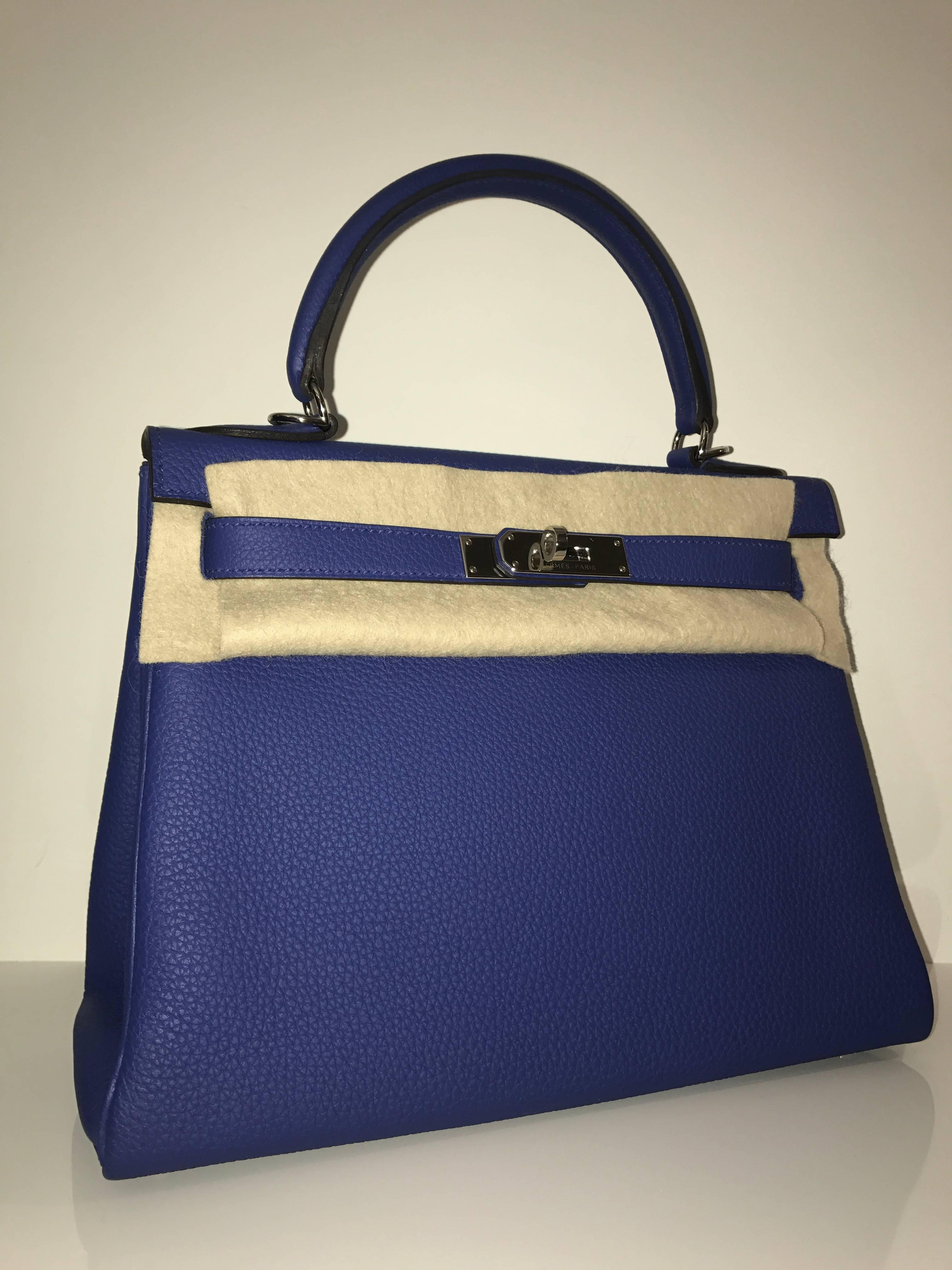 Hermes 
Kelly Size 28
Togo Leather 
Colour Electric Blue  
Silver Hardware
Store fresh, comes with receipt and full set (dust bag, box...) 
Hydeparkfashion specializes in sourcing and delivering authentic luxury handbags, mainly Hermes, to clients