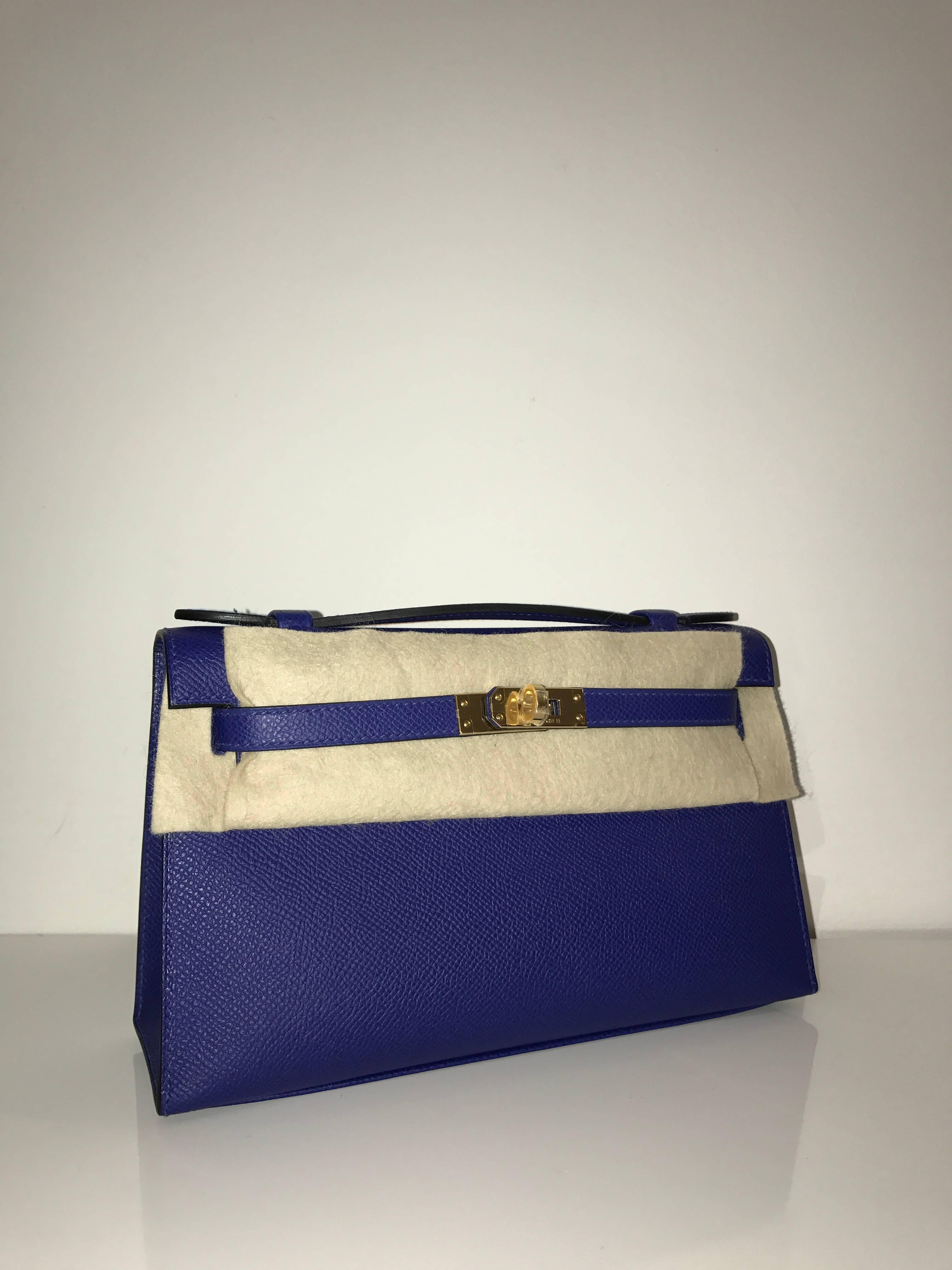 Hermes 
Kelly Pochette
Epsom Leather 
Colour Electric blue 
Gold Hardware
Store fresh, comes with receipt and full set (dust bag, box...) 
Hydeparkfashion specializes in sourcing and delivering authentic luxury handbags, mainly Hermes, to clients