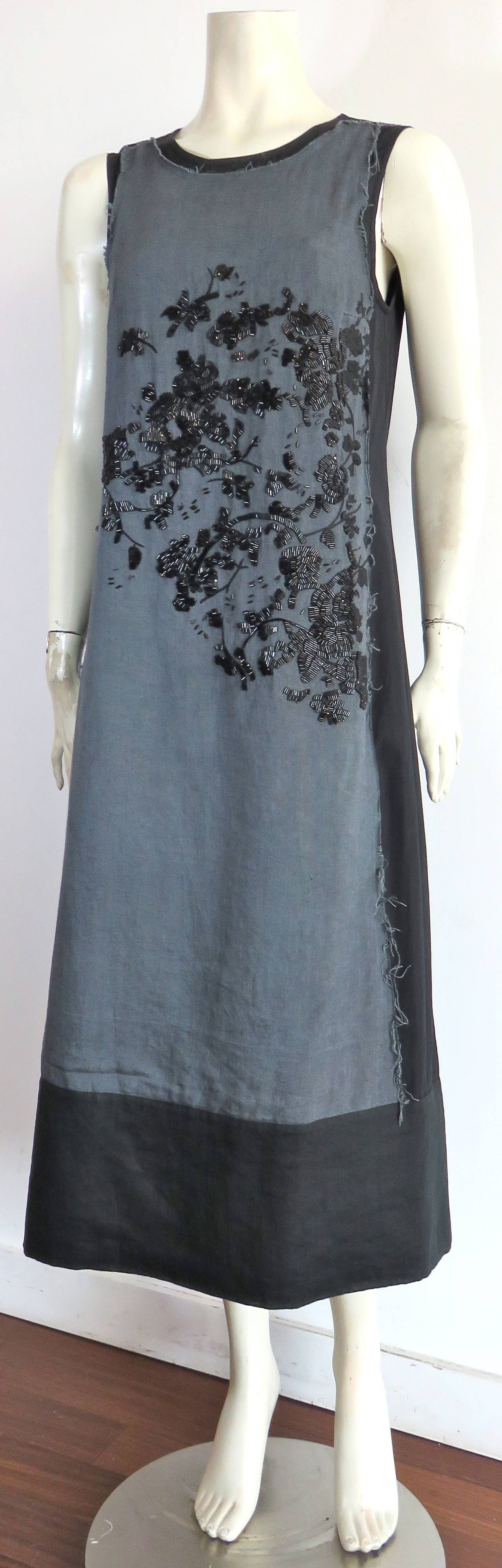 Excellent condition, DRIES VAN NOTEN Belgian linen dress with floral beading and embroidery.

The gray, belgian linen dress panel is stitched down to the front of the dress with raw-edged finishing at the edges. The front, woven panel features a