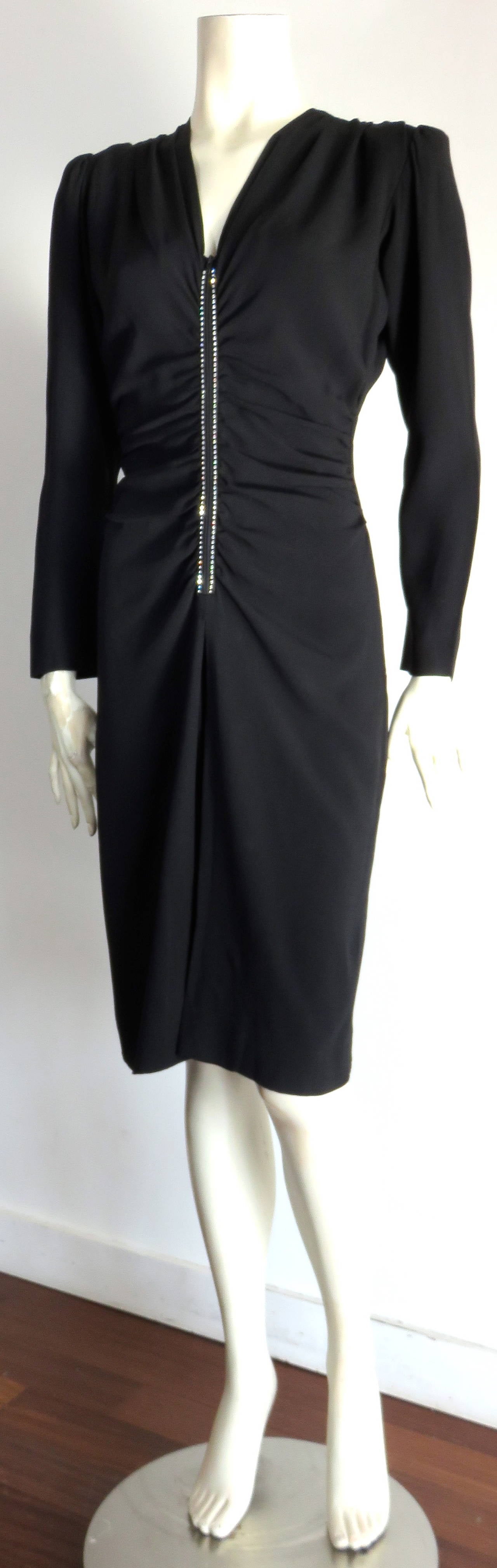 Stunning, 1970's YVES SAINT LAURENT 40's style cocktail dress.

Mr. Saint Laurent was thoroughly inspired by the silhouettes of the 1940's, updating them for the 70's, and this dress is of no exception.  

The dress features soft, ruche