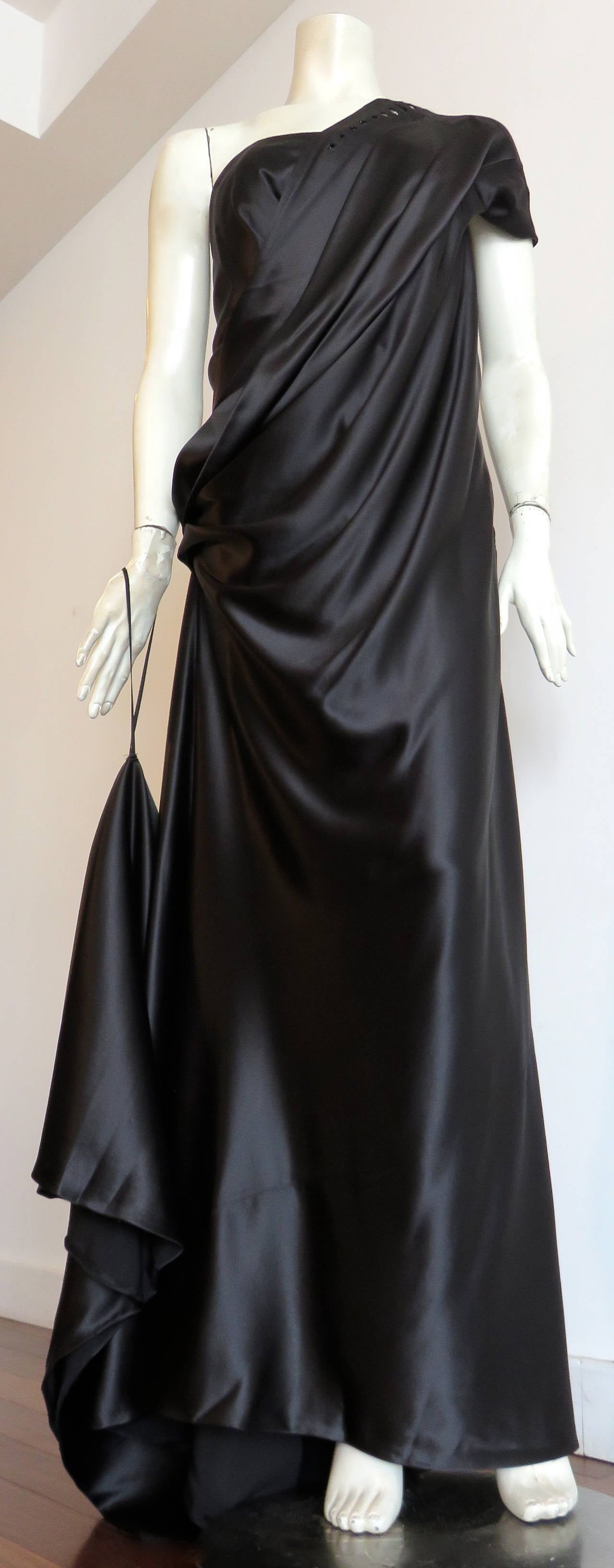 Worn once, and in excellent condition MARC JACOBS COLLECTION, black silk, charmeuse evening gown with train detail.

This stunning gown features square-shaped, cut-out seaming with beaded inner corners at left front shoulder, and along the lower