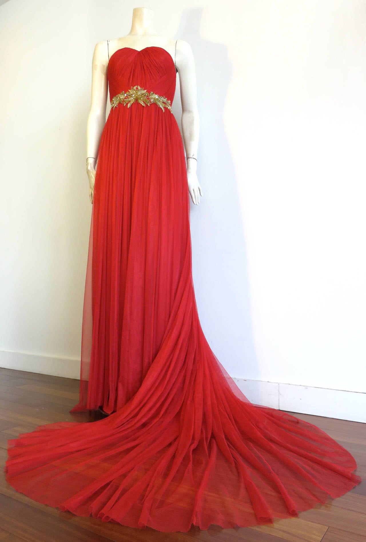 Worn once for an event, MARCHESA Scarlett red & metallic gold evening gown.

This stunning evening dress is made of gathered tulle atop nude-tone silk foundation/lining.

The waist features a gorgeous, leaf embroidery in metallic gold threads