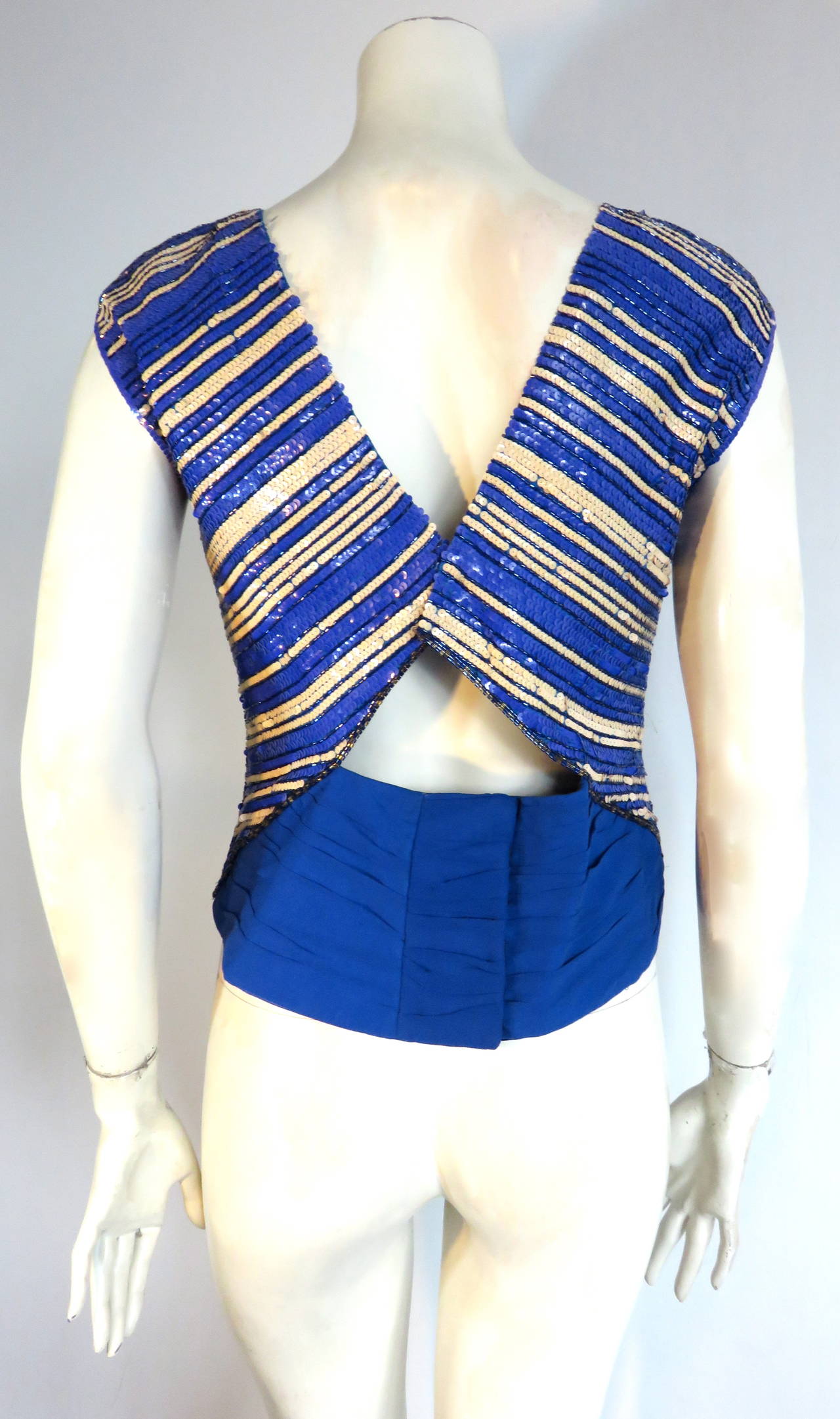 Gorgeous, 1970's CHRISTIAN DIOR Sequin & beaded evening top.

This stunning evening top features multi-striped rows of azure blue, and ivory white sequins with individual rows of hand-beaded stripes, bordering the rows of sequins.  

The