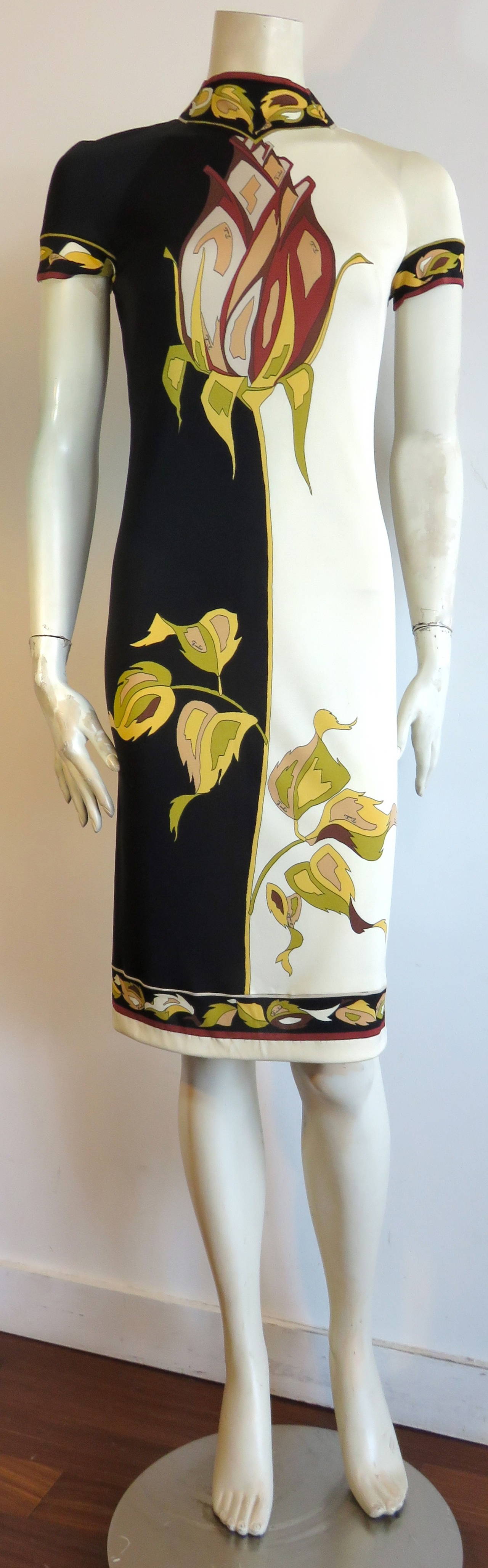 Early 1970's, EMILIO PUCCI 'Long stem rose' printed silk jersey knit dress .

50/50, black and ivory ground artwork with signature Pucci, long stem, vertical rose bisecting the center-front.  

Seamed, leaf border print panels at the center-back