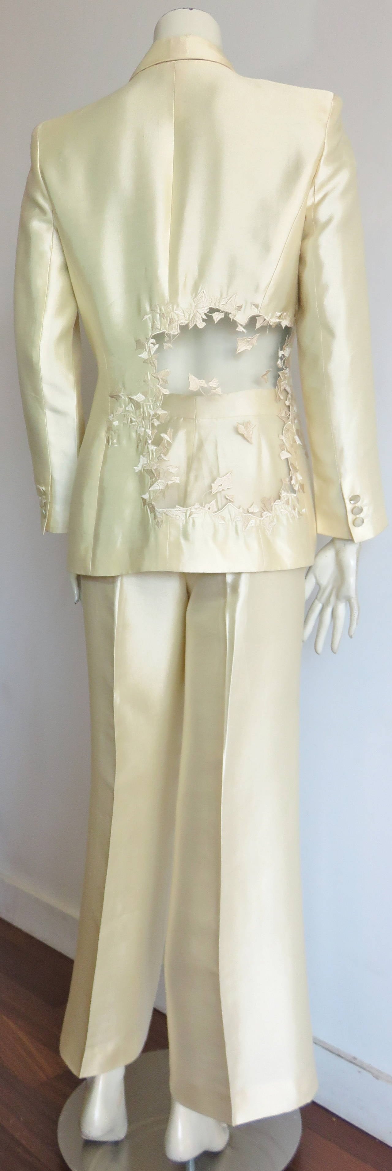 1990's ALEXANDER McQUEEN Women's embroidered satin tuxedo suit.

Gorgeous mesh, cut-out 'window effect at lower, back right panel of jacket.  The cut-out construction is embroidered with ivy leaf edge detail motifs with embroidery onto the sheer