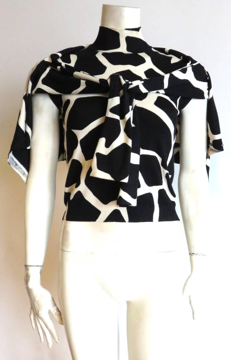 Excellent condition, 1990's, JOHN GALLIANO PARIS Giraffe print silk sweater twinset.

Two-piece, cardigan, and sweater top set with mini, smoked pearl button closures.  

Cardigan neckline, and top armholes feature pinked-edge