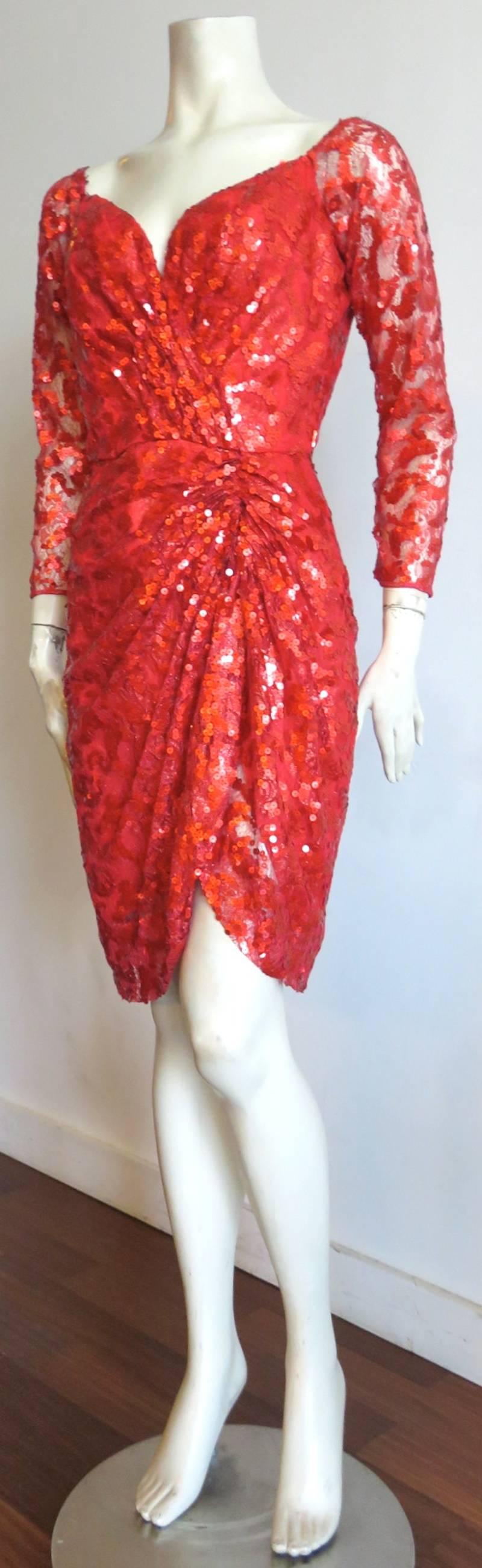 Excellent condition, 1980's, VICKY TIEL COUTURE, sequin & lace cocktail dress in ruby red.

'Sweetheart' style neckline with internal, boned bodice.

Gathered, sarong-style skirt bottom.

Main dress is fully lined.  Sleeve are semi-sheer with
