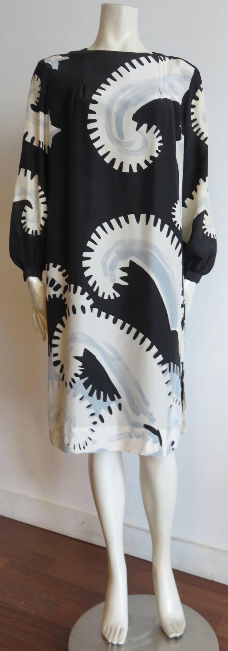 Excellent condition, 1980's MICHAELE VOLLBRACHT printed silk dress.

Gorgeous, painted artwork featuring jagged, paisley-style spirals in ivory and gray atop black ground.

Triple, darted construction detail at top front, and back.

Key-hole