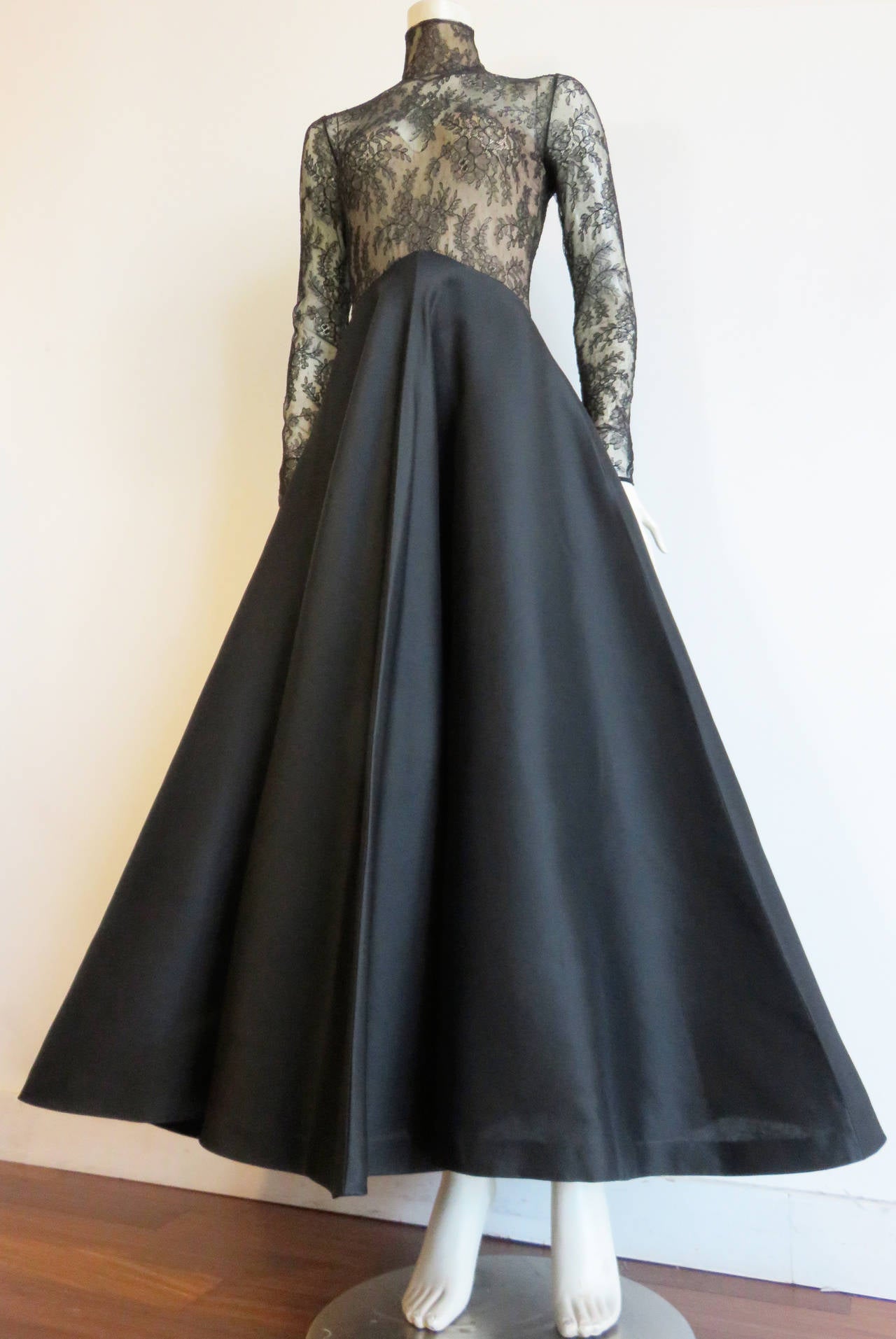 Worn once, 1980's JEAN-LOUIS SCHERRER COUTURE Black, Chantilly lace evening gown dress in beautiful floral pattern design.

This gorgeous evening gown features stretchy, semi-sheer, black lace top bodice with long sleeves.  The mid-torso features