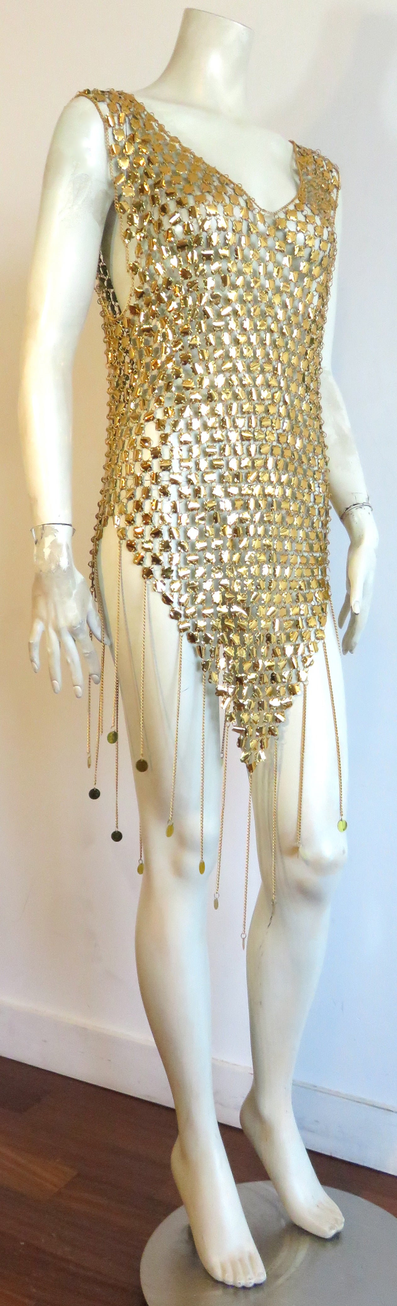 Excellent condition, 1970's metallic poolside/beachwear 'cover-up' tunic.

This stunning tunic is made of all-over, gold-foil coated PU paillettes .  Each paillette is linked together at the edges with small metal rings.  The neckline, and