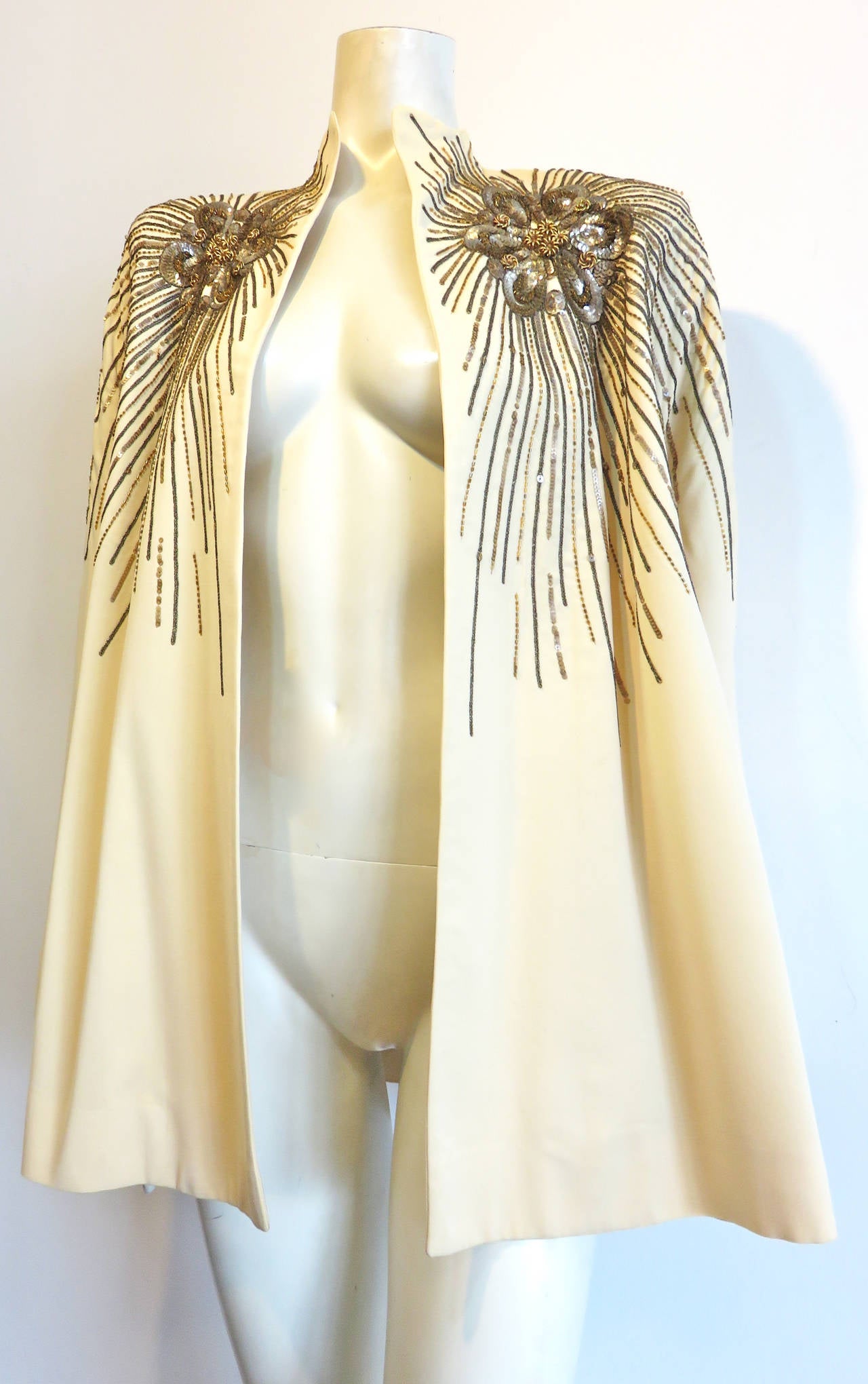 Early 1940's, BONWIT TELLER, Schiaparelli inspired swing coat.

Designed approximately 2 years after Elsa Schiaparelli's 'Apollo of Versailles' cape of 1938, this Bonwit Teller New York label, swing coat features two beautifully embellished