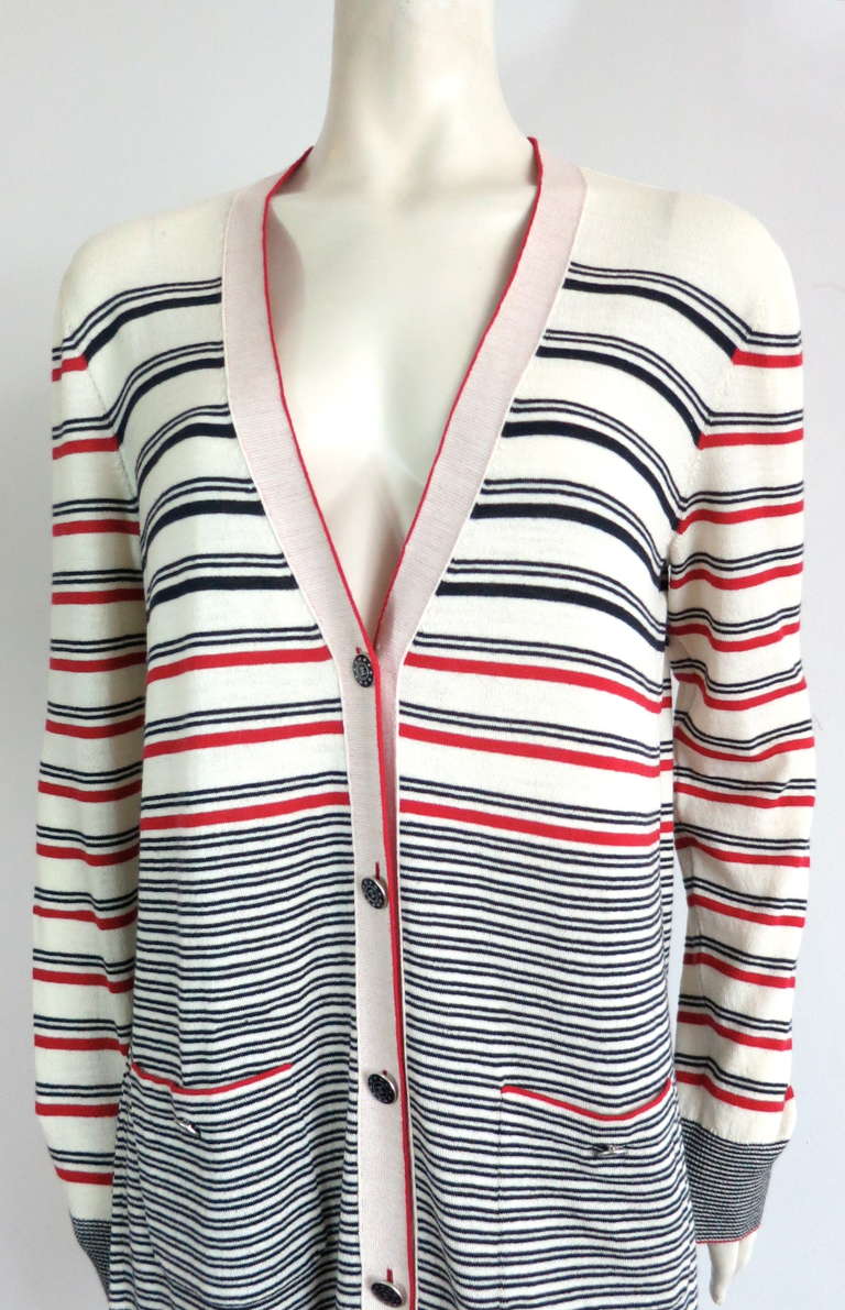 Excellent condition CHANEL PARIS wool/cotton/cashmere knit sweater cardigan in ivory with red and blue stripes

Monogram 'CC' logo enamel and metal buttons with star detail border at front placket and waist pockets

Solid red knit detailing at