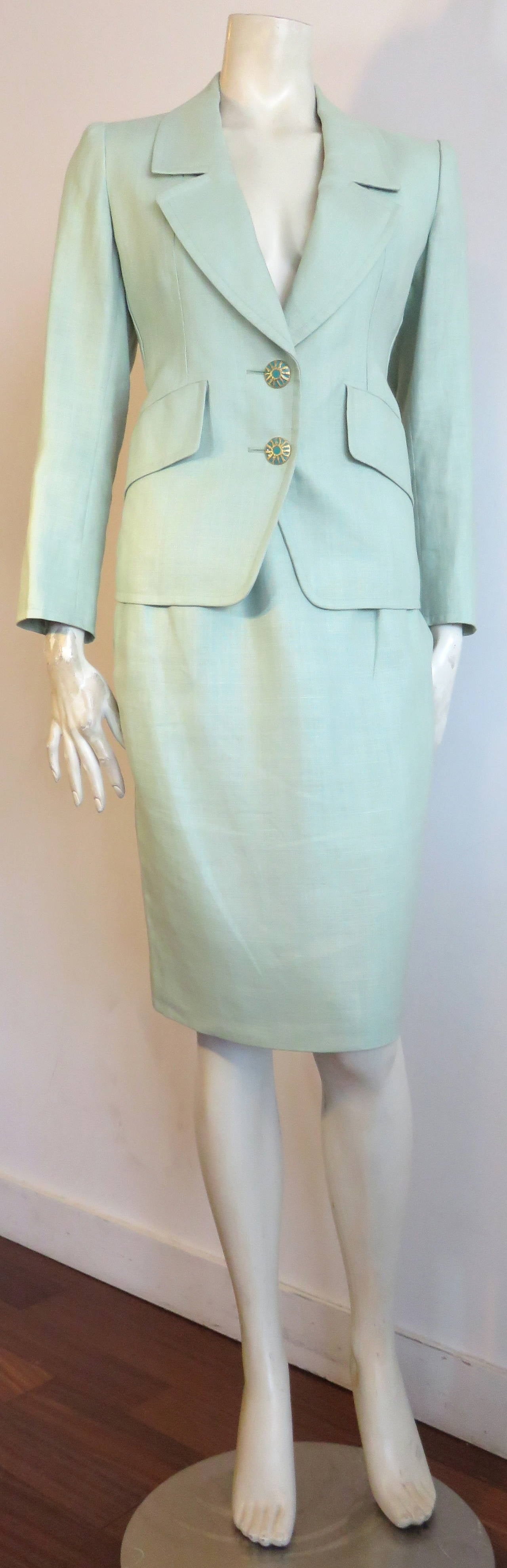 Excellent condition, 1990's YVES SAINT LAURENT, pale, sea-green, linen skirt suit with beautiful, enameled turquoise & gold-finished buttons.

Twin front button closures at front placket, and sleeve cuffs.  

Generously shaped front lapels, and