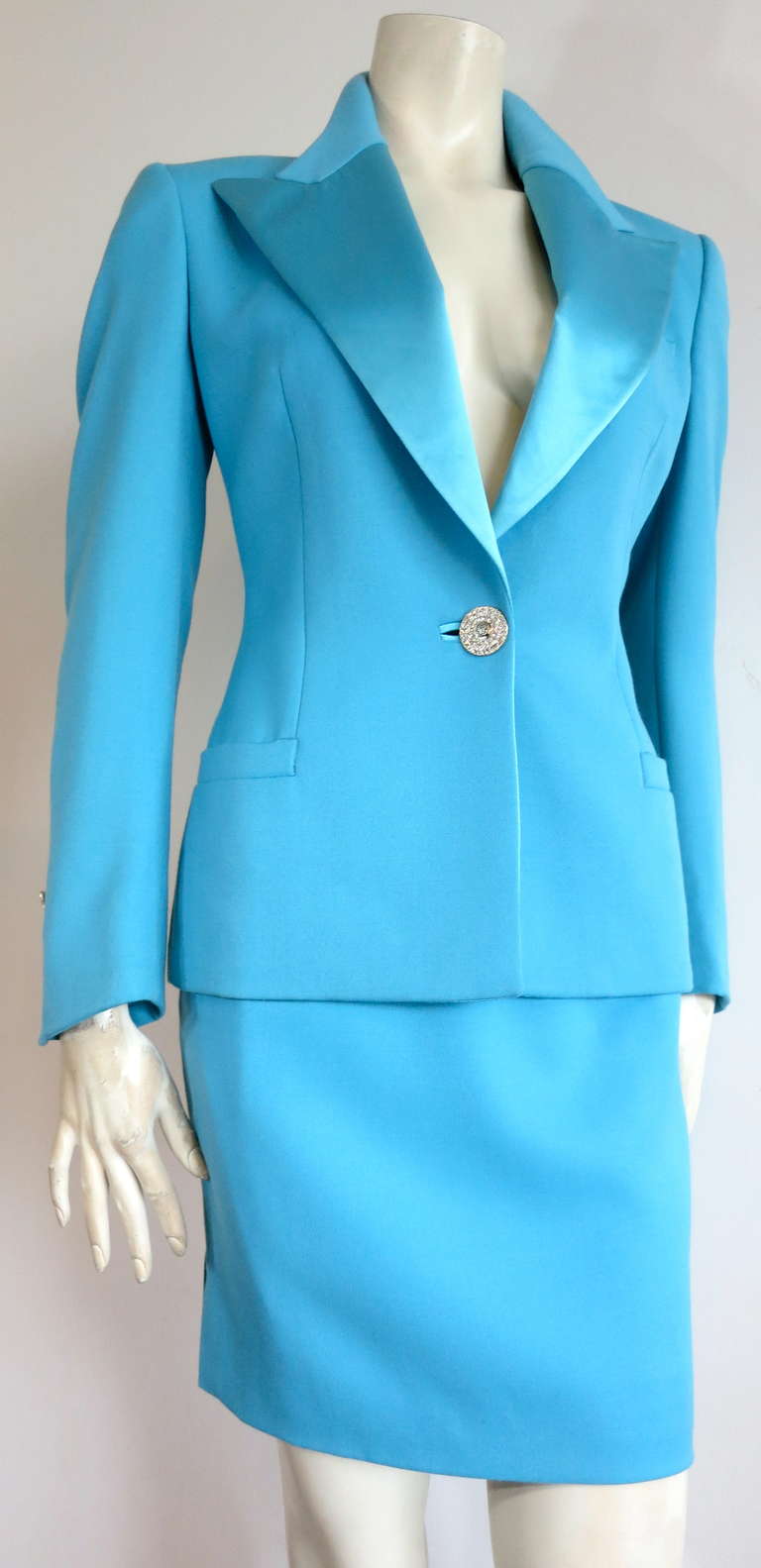 Early 1990's GIANNI VERSACE COUTURE Turquoise skirt suit.

This stunning skirt suit was designed by Gianni Versace in Italy during the early 1990's.

The jacket features silk satin, peak lapels with crystal embellished, Medusa head engraved