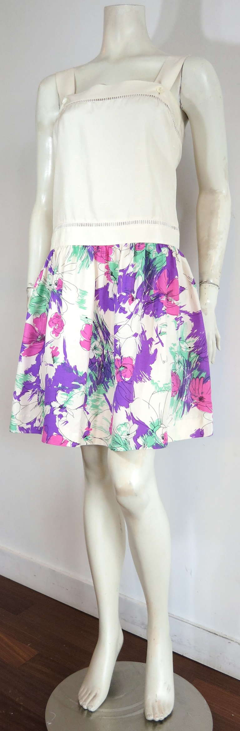 Excellent condition CELINE PARIS Silk floral dress.

This lovely dress was designed by the house of Celine in France during the 1980's.

The top of the dress is made of ivory/lt. creme color silk Shantung weave fabric , and features embroidered