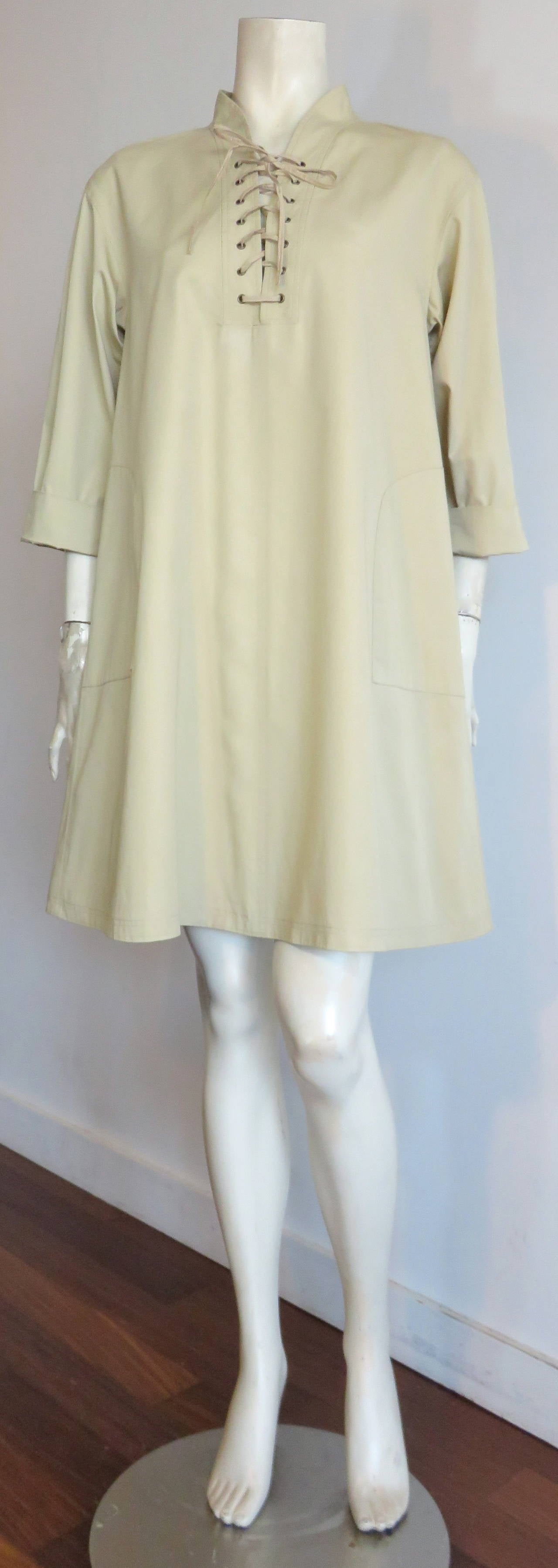 Great condition, 1990's YVES SAINT LAURENT Safari tunic dress.

Loose-fit, 'A-line' silhouette, tunic dress with iconic, YSL lace-up front construction.

Cuffed, 3/4-length sleeves.

Made in France, as labeled.

*MEASUREMENTS*

FR Label