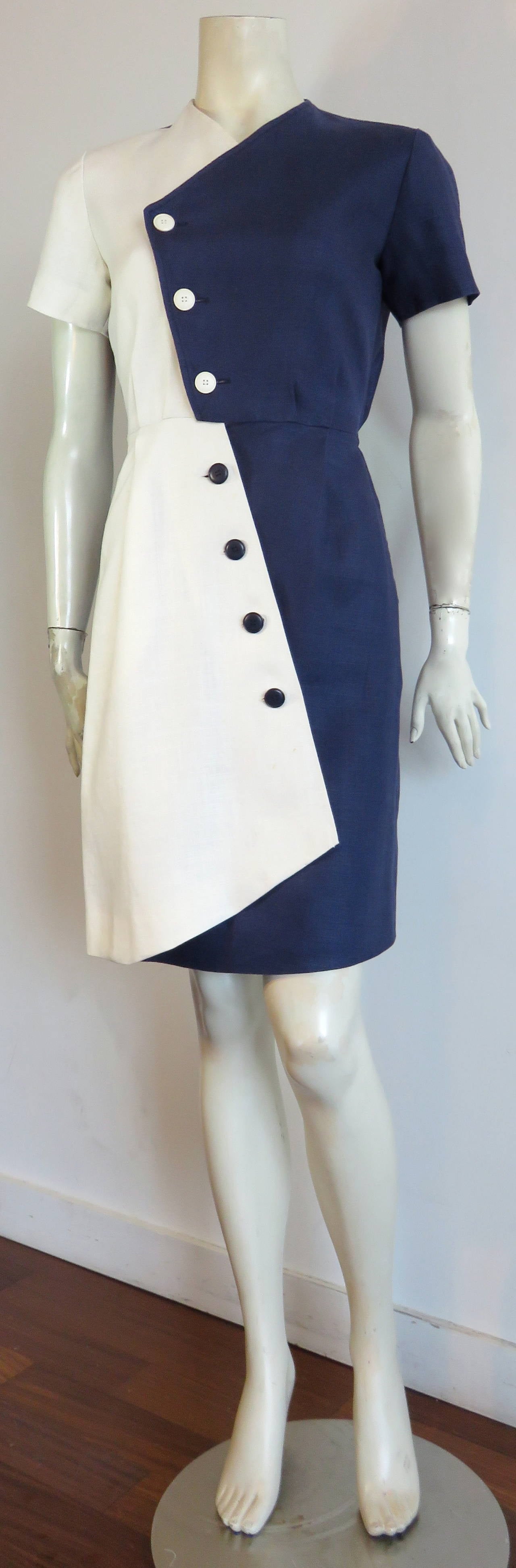 1980's YVES SAINT LAURENT, Cubist style, linen day dress.

Navy blue and white, color-blocked design with angled front placket, and inverse button color placements.

Fully lined dress with concealed side pockets, and internal hook