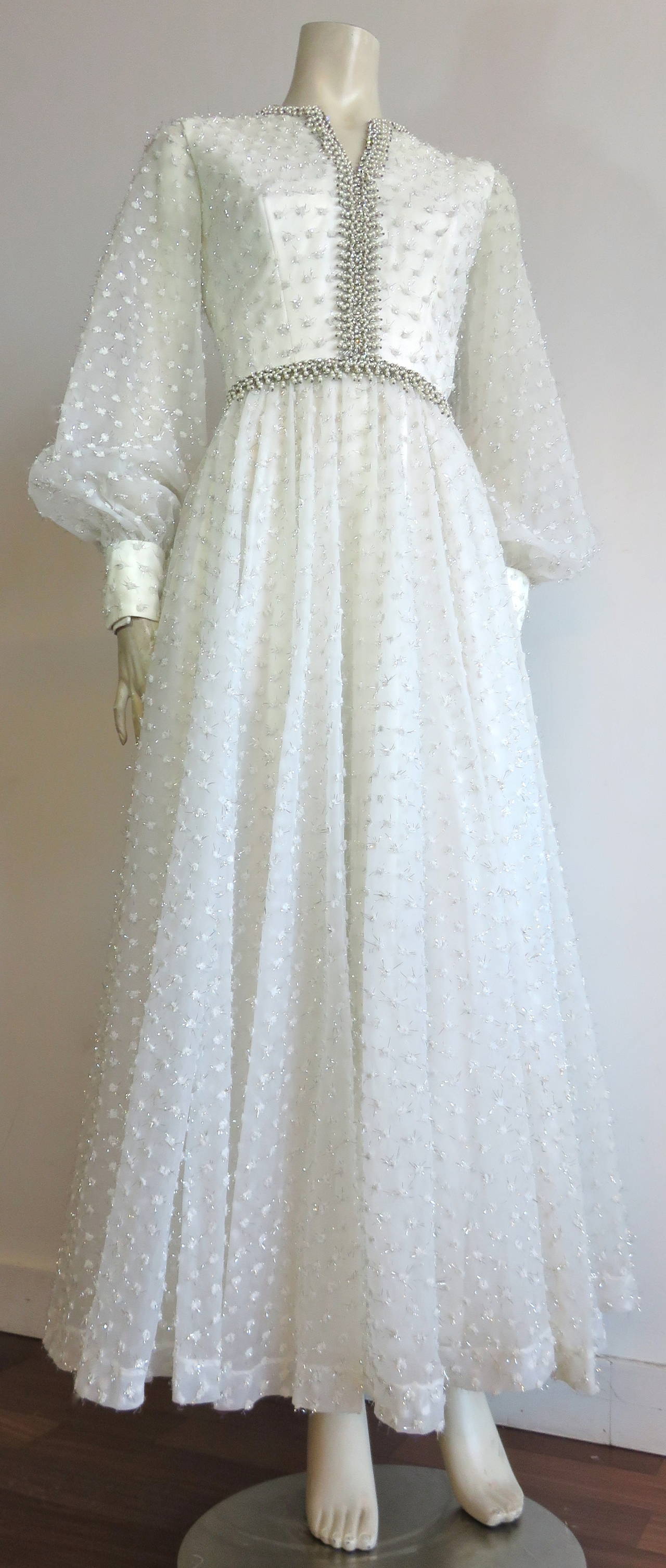 Excellent condition, 1960's, ROSE TAFT Couture dress with pearl beading.

Dazzling, pearl-white dress with all-over chenille, and metallic silver, Swiss-dot patterning.  The plush, mini-pom dots of the Swiss-dot patterning is accented with