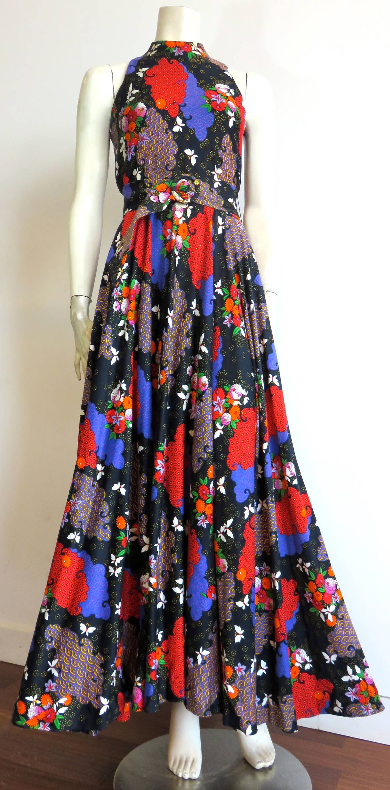 Gorgeous, 1970's, GEOFFREY BEENE BOUTIQUE, floral print dress & belt.

Dark midnight blue, knit jersey base cloth with multi-color, floral, bouquets, white butterflies, and geometric pattern fills.

Adjustable, matching belt with ring slider,