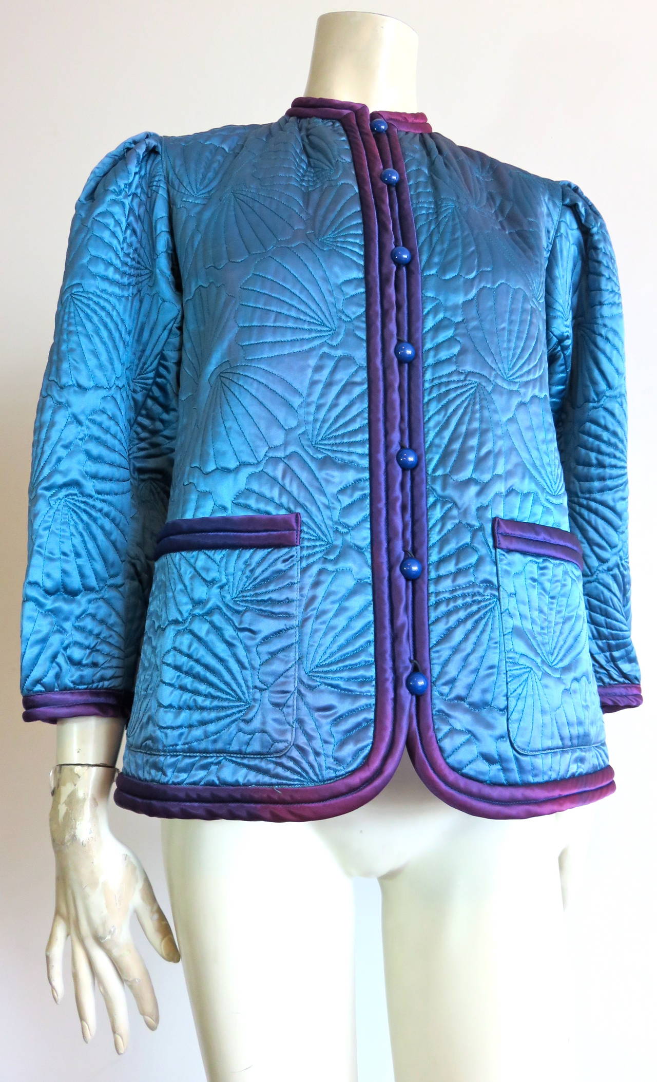 Beautiful, 1970's, YVES SAINT LAURENT Turquoise satin jacket with twin, purple corded trim detail.

Signature YSL jacket silhouette during the 1970's.

All-over, scallop-shell design, quilt-stitching with light padding within the