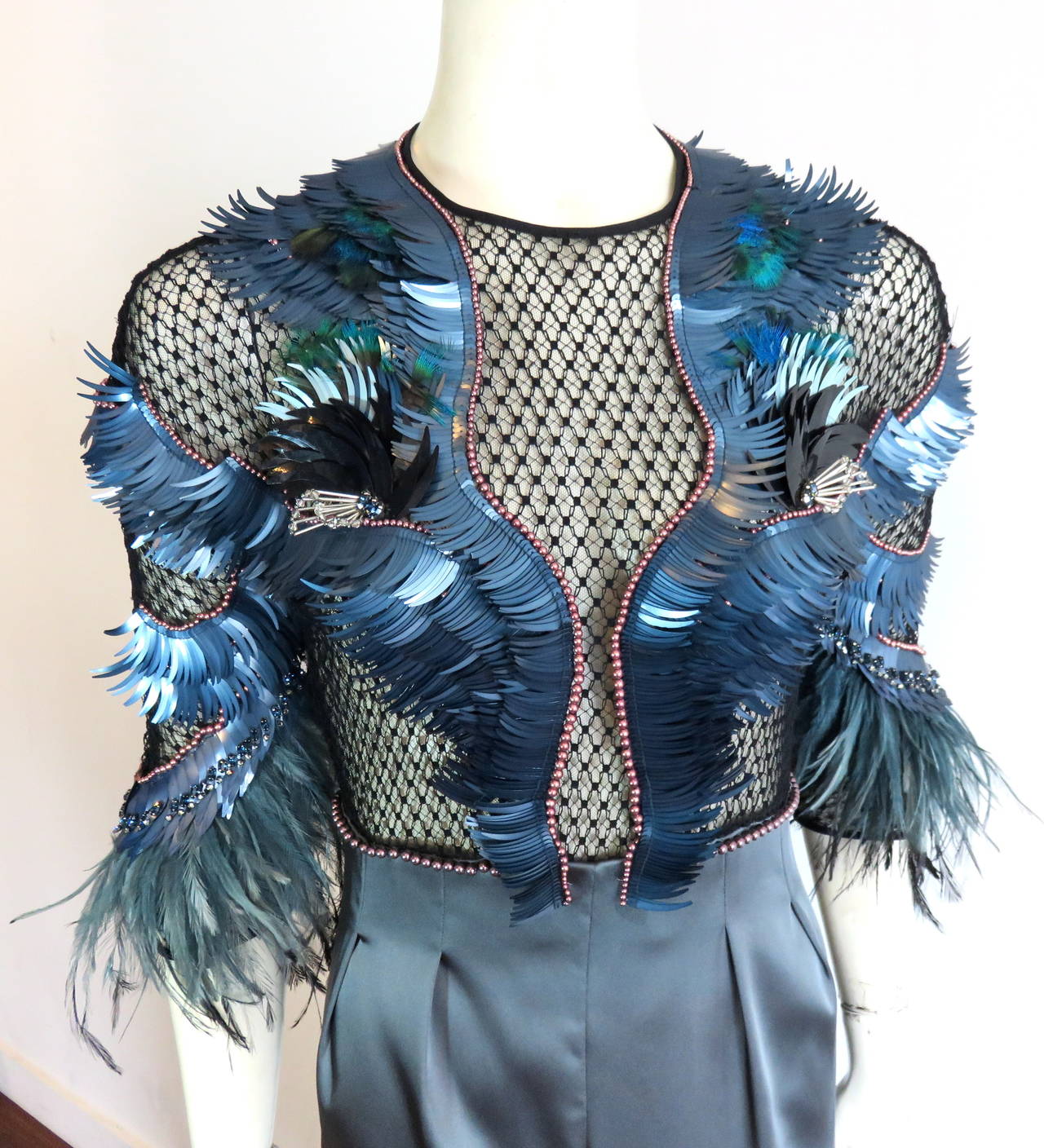 Stunning, 2013 GUCCI ITALY 'Bird of Night', embellished evening dress.

This incredible evening dress features amazing embellishments in night blue/gray, feather-shaped sequins with sparking rhinestones, ostrich plume feathers, and tahitian,