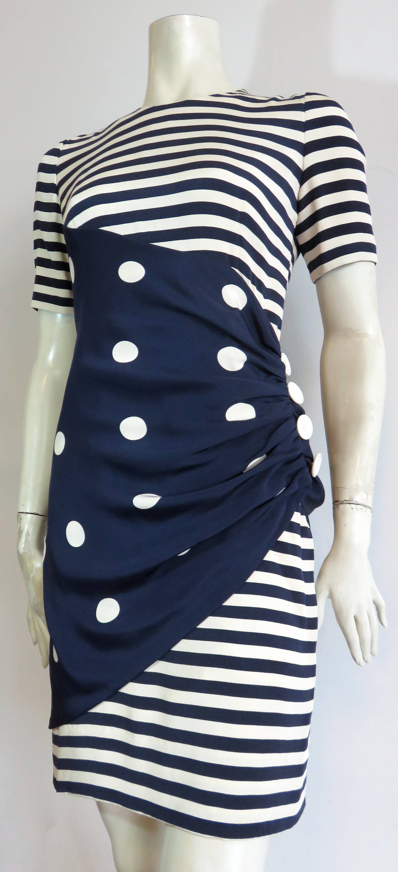 Excellent condition, 1970's, BILL BLASS, Nautical silk dress.

Ivory and navy blue stripe shell with polka dot, draped sarong-inspired detail at waist level, with functioning side button detail.

Concealed, center-back zipper entry.

Fully