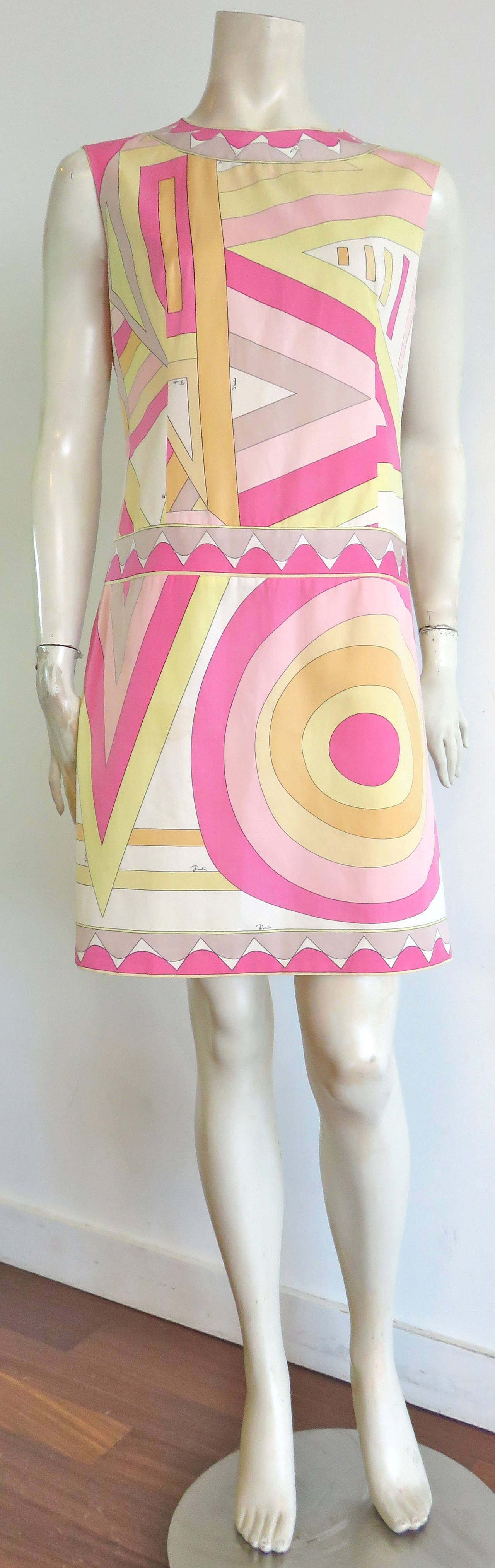 1960's EMILIO PUCCI Pastel geometric printed dress.

Signature, printed artwork atop cotton twill base cloth.

Engineered border artwork at neck, waist, and hemline.

Darted construction at neckline.

Dropped waist, 1920's inspired