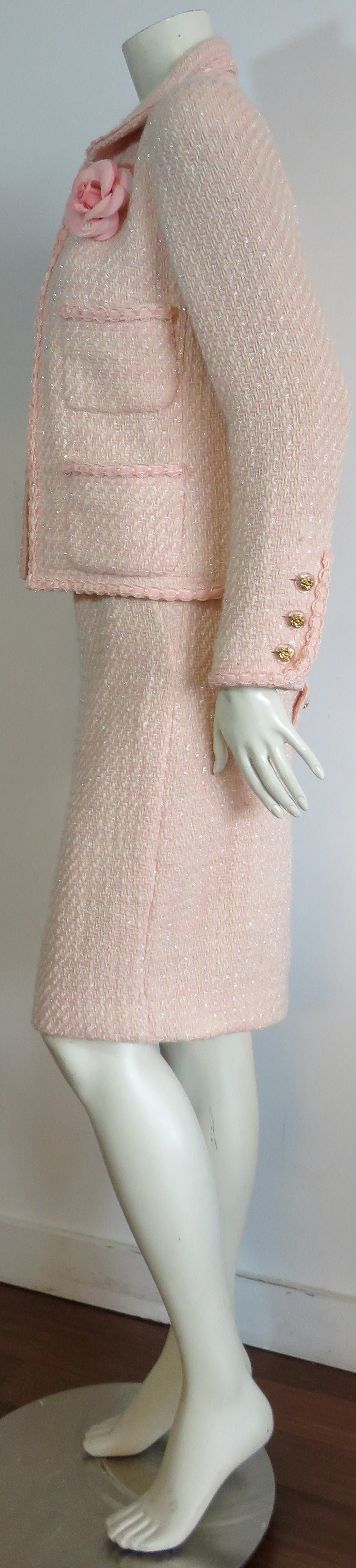 Excellent condition, classic CHANEL PARIS 2pc. skirt suit.

Beautiful, pale pink & ivory woolen tweed fabrication with subtle, cellophane chenille yarns woven within, giving the fabric a slight shimmer/shine effect when reflected in the