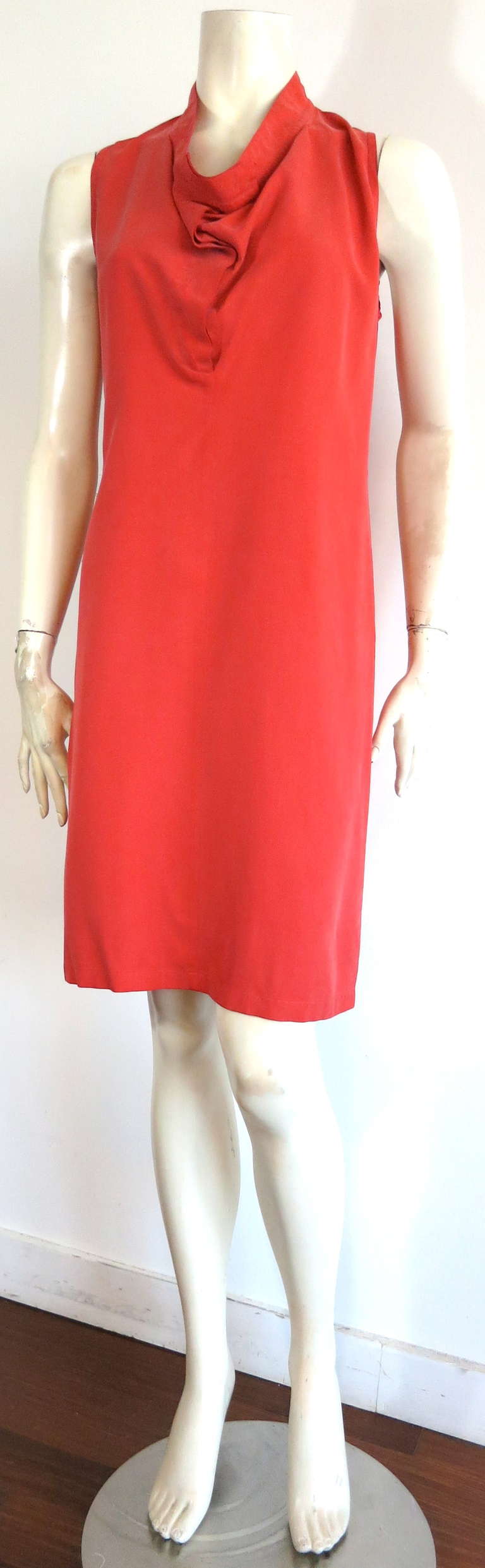 1990's ANN DEMEULEMEESTER washed, coral color silk day dress.

The dress was designed by Ann Demeulemeester in the 1990's, and was made in Belgium, as labeled.

The dress features a wonderful neckline inspired by the construction of a trouser
