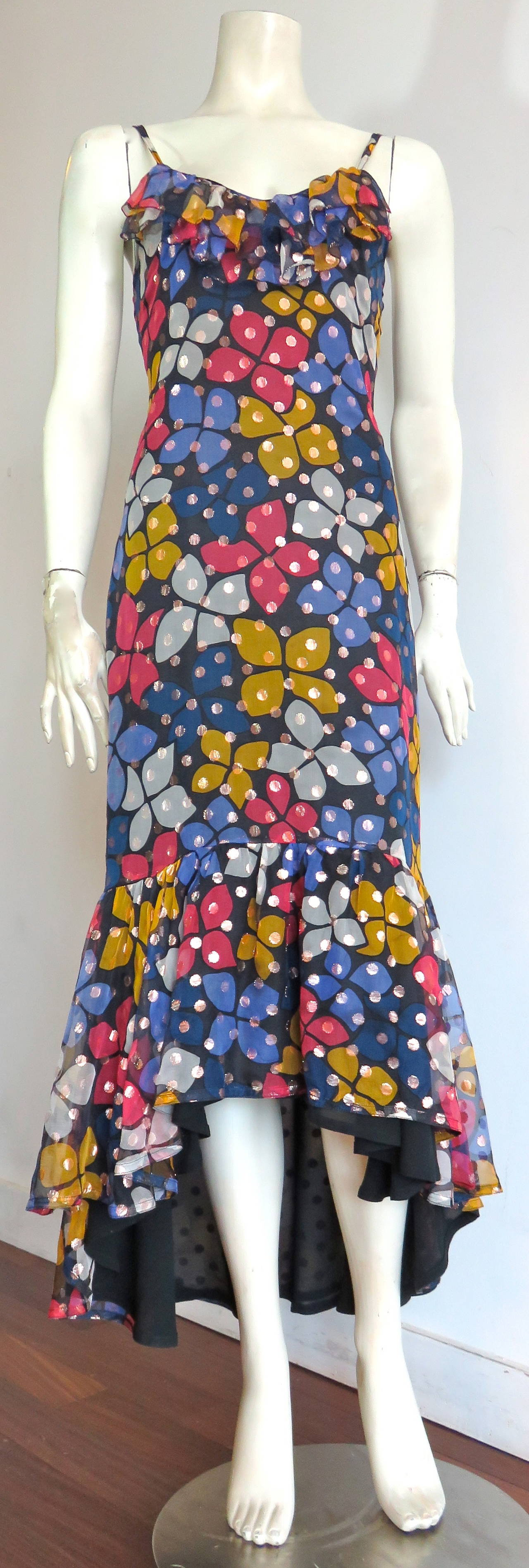 Excellent condition, 1970's, SONIA RYKIEL metallic silk floral dress.

This fabulous dress features a multi-color, floral printed artwork with dark, midnight, blue ground, and metallic gold, woven dot pattern within the fabrication.

Ruffle