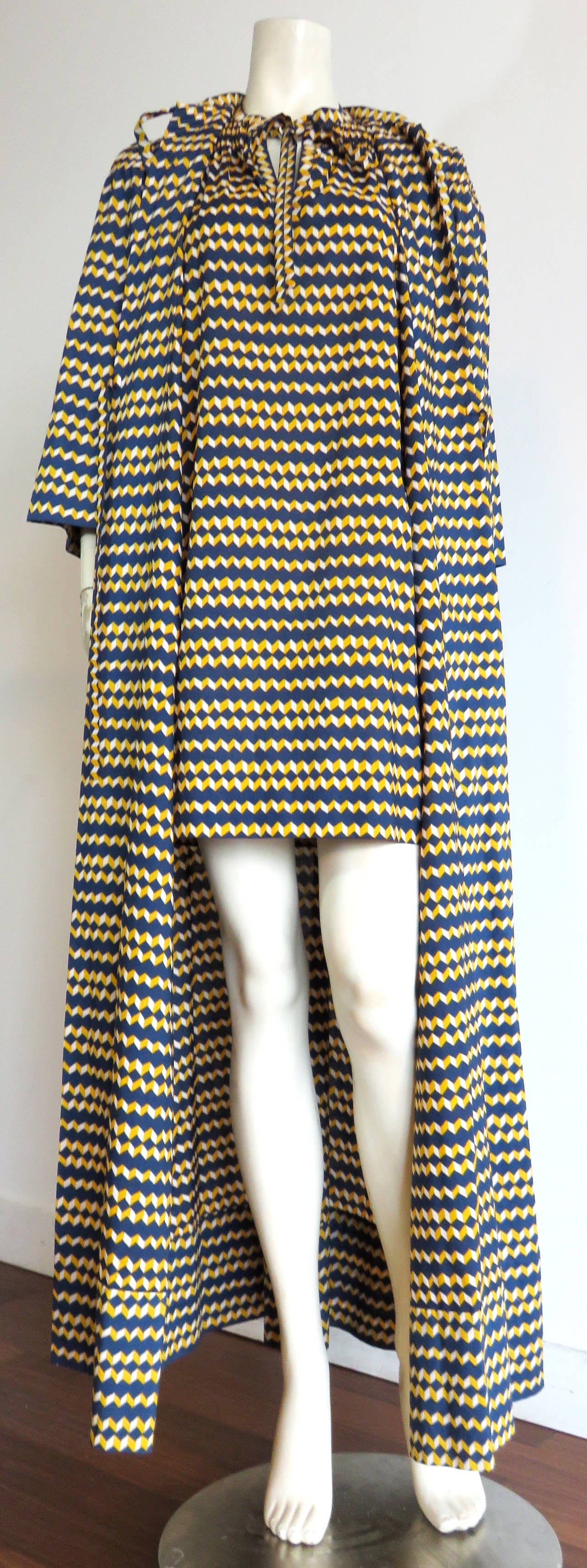 Never worn, 1970's, GIVENCHY Couture, 2pc., chevron striped robe & tunic dress set.

Both the long robe, and matching tunic dress are made of crisp, printed cotton fabrication in marine-blue ground with golden-yellow, and white chevron stripes. 