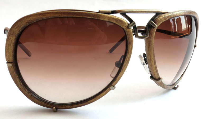 Vintage BOTTEGA VENETA Women's aviator sunglasses.

These wonderful, top-bar sunglasses were created by Bottega Veneta during the 1980's in Italy, as marked.

Oversized lens shape with metal hook design around rims.

Brushed, brass metal