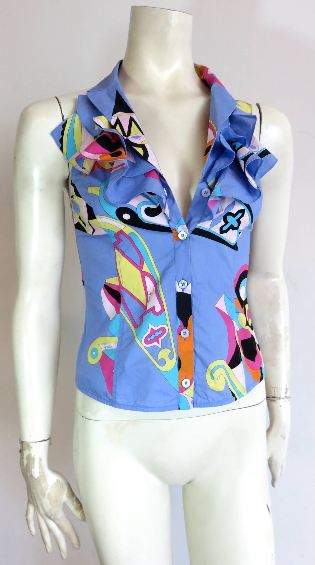 Excellent condition, EMILIO PUCCI, signed, geometric printed cotton shirt.

Sleeveless style with wonderful ruffle detail at front bib.

Racer style back armholes.

Logo engraved, button front closures.

Made in Italy, as