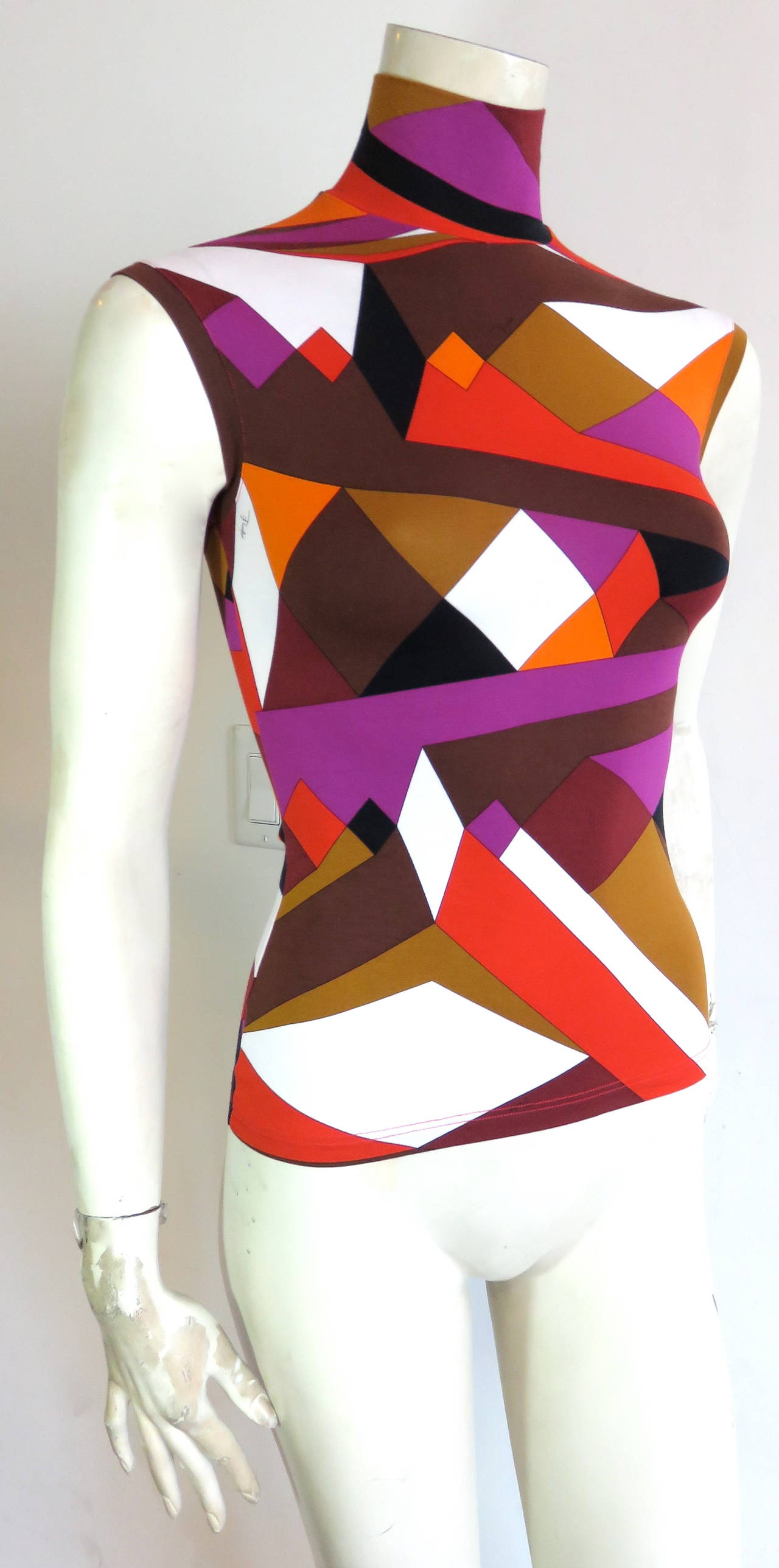 EMILIO PUCCI Geometric knit top.

Signed artwork atop stretchy knit fabric.

Sleeve-less, mock-turtle neckline

Made in Italy, as labeled.

*MEASUREMENTS*

There is no size label attached.  We estimate the top to be a US size 6, and is