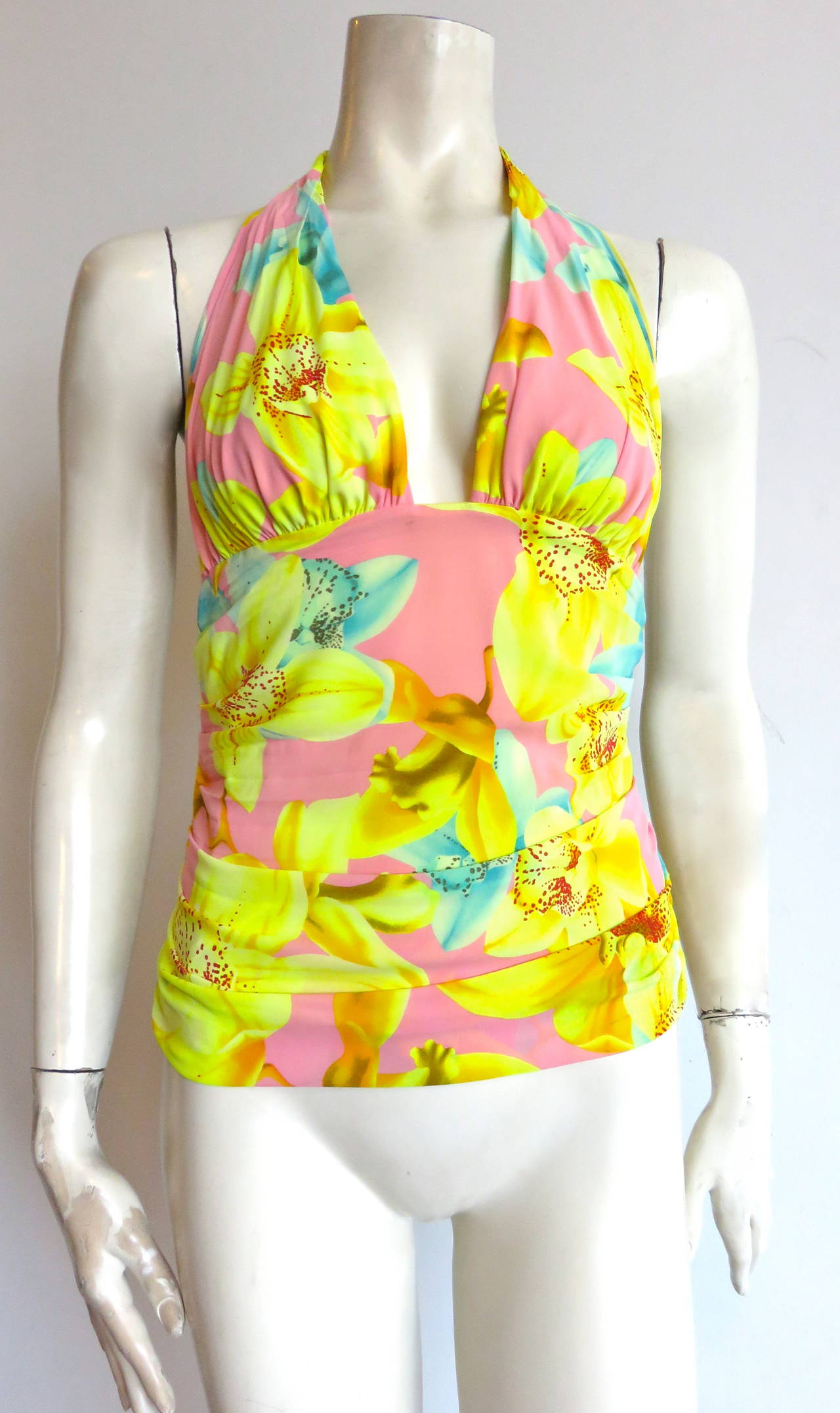 Worn once, excellent condition, VERSACE, tropical orchid, printed silk halter top.

Stretchy silk fabrication with ruche/gathered construction at the sides, and concealed zipper, side seam closure.

Made in Italy, as labeled.

In excellent