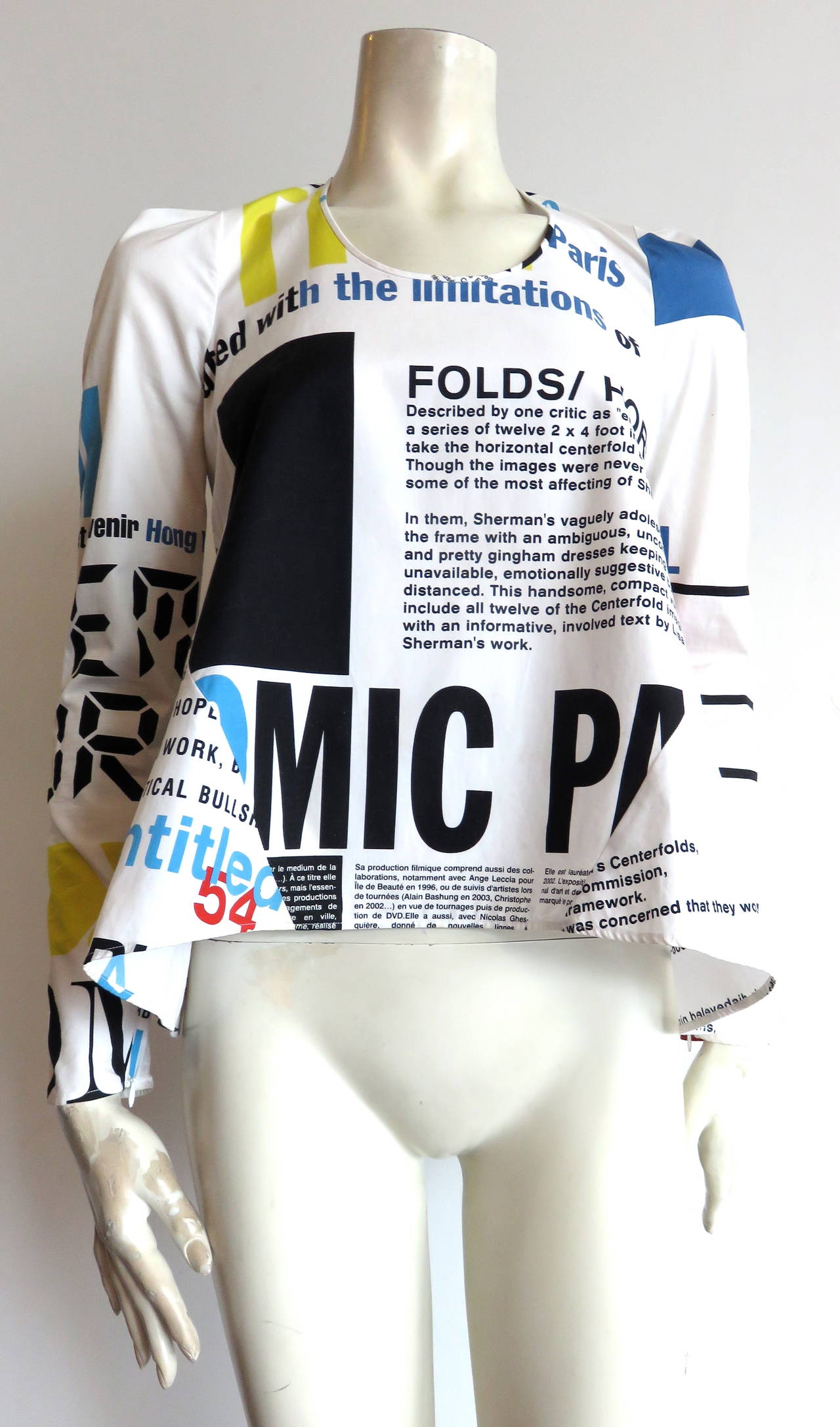 2010 BALENCIAGA by Nicolas Ghesquière printed top featuring text regarding the work of Cindy Sherman.

Bold, digital, type-face style print with color block rectangles.

Flared, 'A'-line silhouette with scooped neckline.

Concealed,