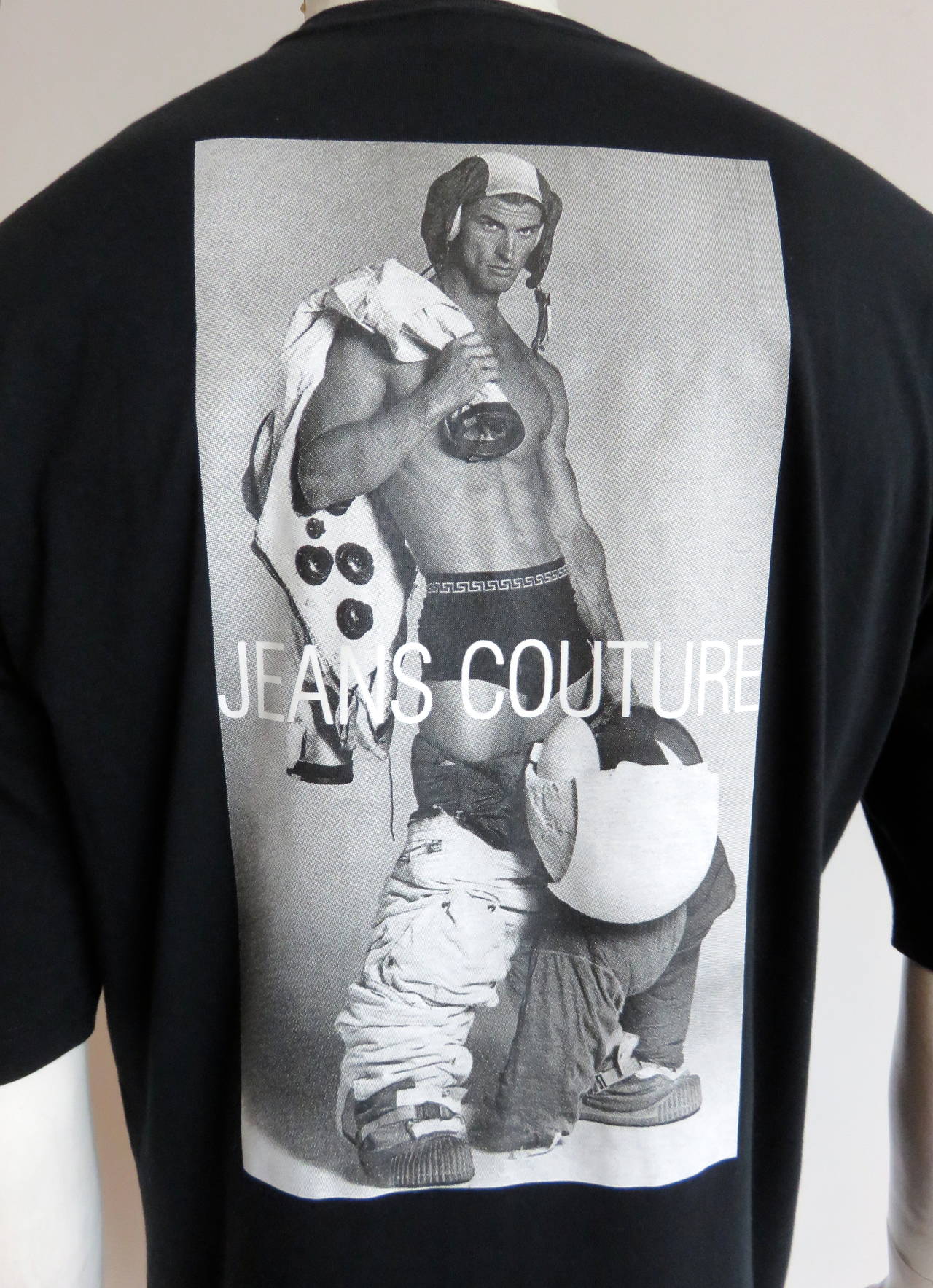 Never worn, 1990's VERSACE JEANS COUTURE t-shirt featuring, BRUCE WEBER photo print at front and back.

Large 'VERSACE' logo at front with male model in (and out of) astronaut suit at front and back.

Small logo plate at bottom of the wearer's